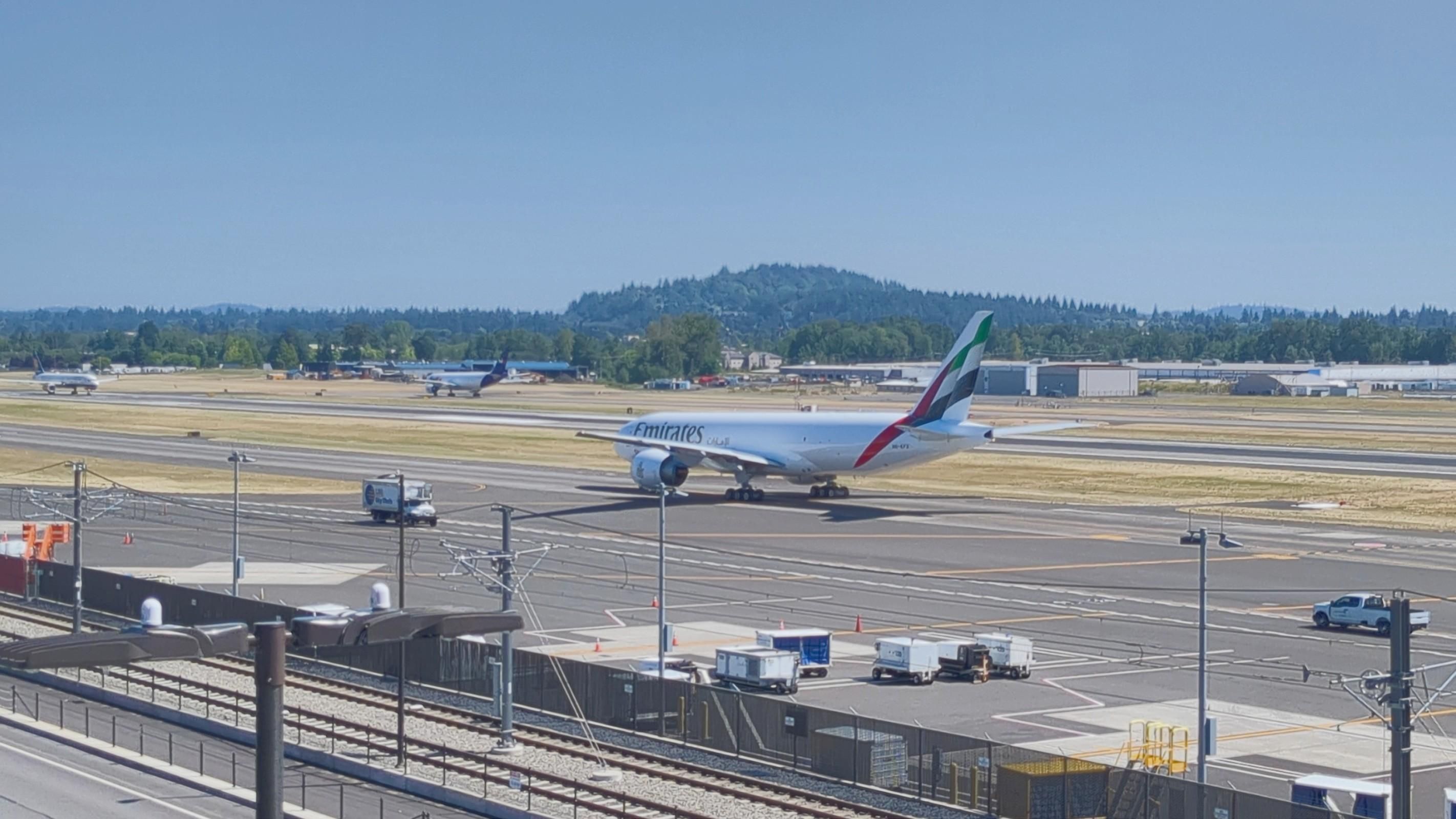 A new Boeing 777-200LR/F freighter taxiing from the Boeing Portland Paint Hangar at Portland Int'l Airport PDX for departure to Boeing Field BFI in Seattle where the customer will complete the purchase and take delivery of the plane.
In the background: a FedEx A300 waits for takeoff while an IcelandAir 757-200 is lined up on the runway to begin its takeoff
photo by Ian Kluft
July 24, 2025
Portland, Oregon, USA
