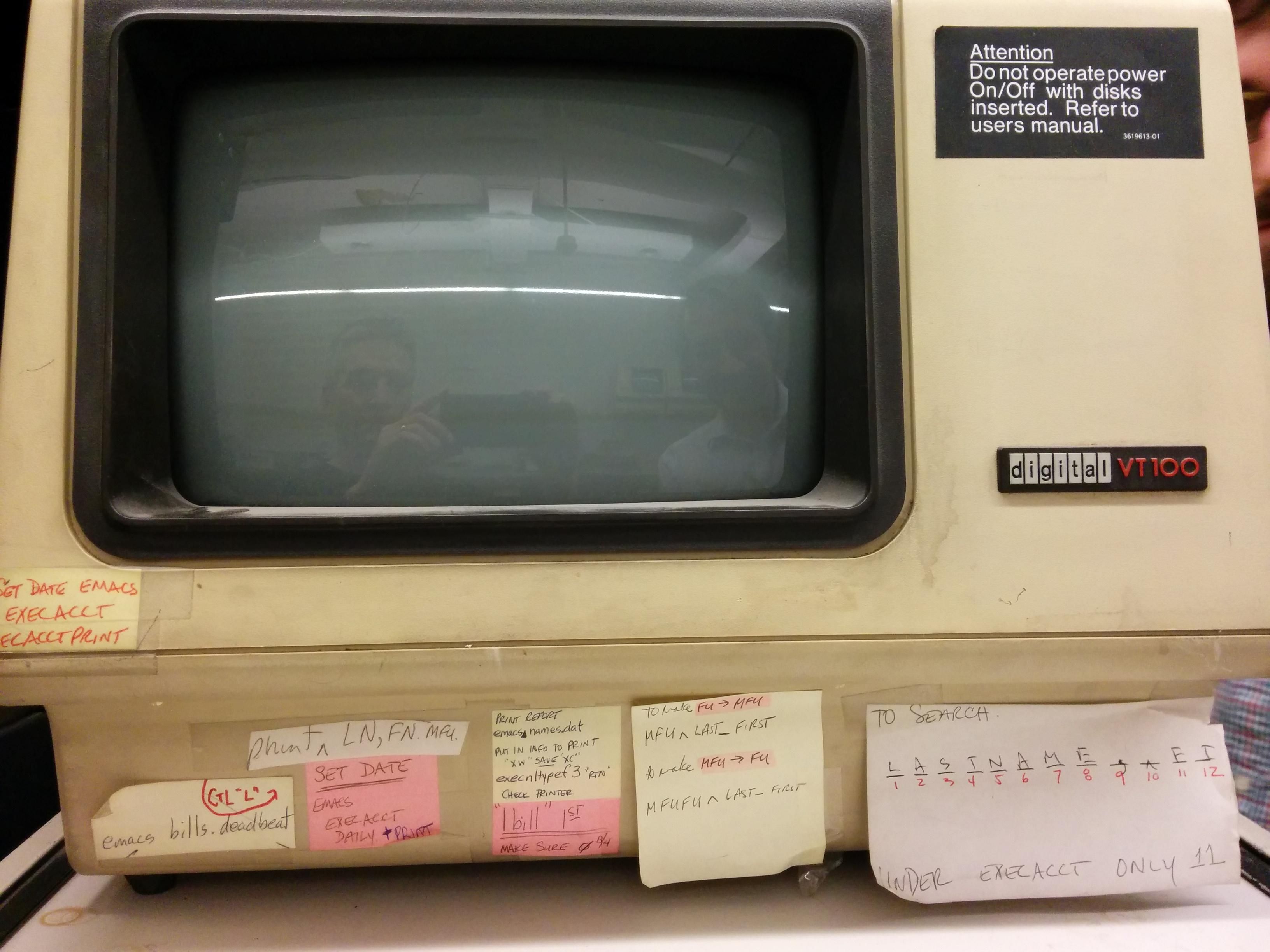 Vt100 terminal with various commands written on sticky notes. One is about starting emacs. 