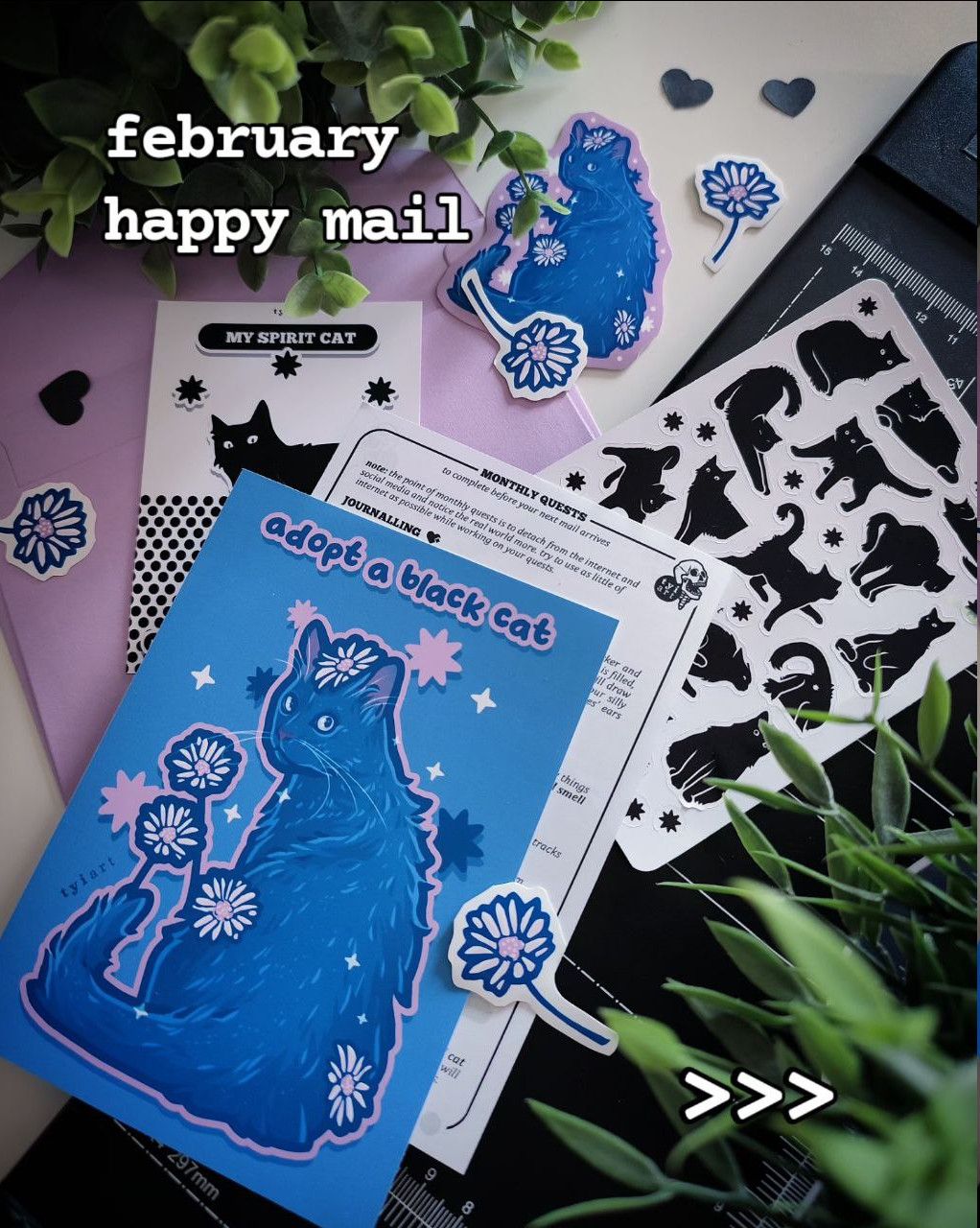 Photo of mail club rewards consisting of art prints, sticker sheet, vinyl sticker and sticker flakes, all about the support of black cats.