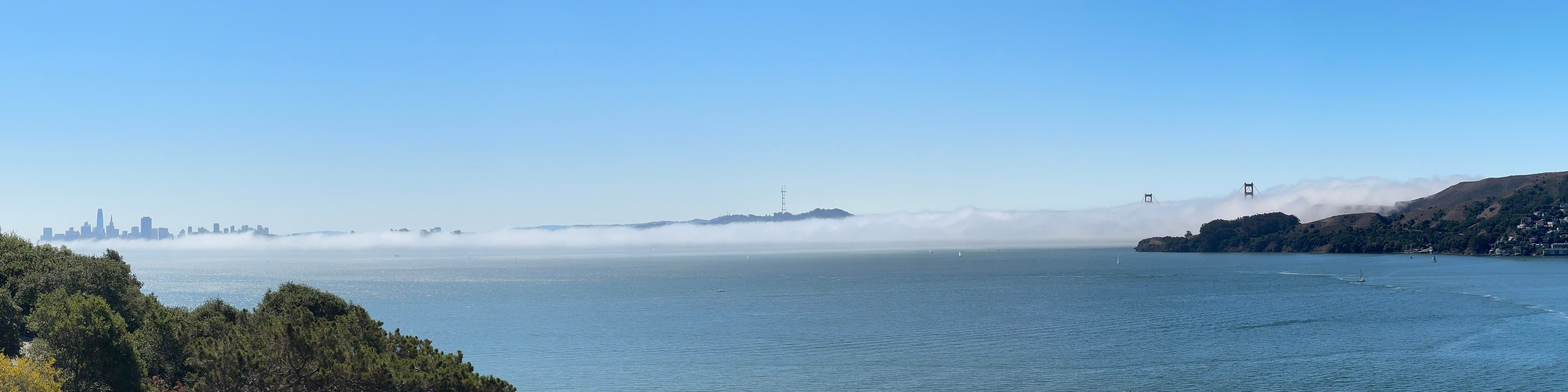 Panoramic photograph of San Francisco and the Marin headlands from Belvedere; most of San Francisco and the Golden Gate Bridge are shrouded in fog