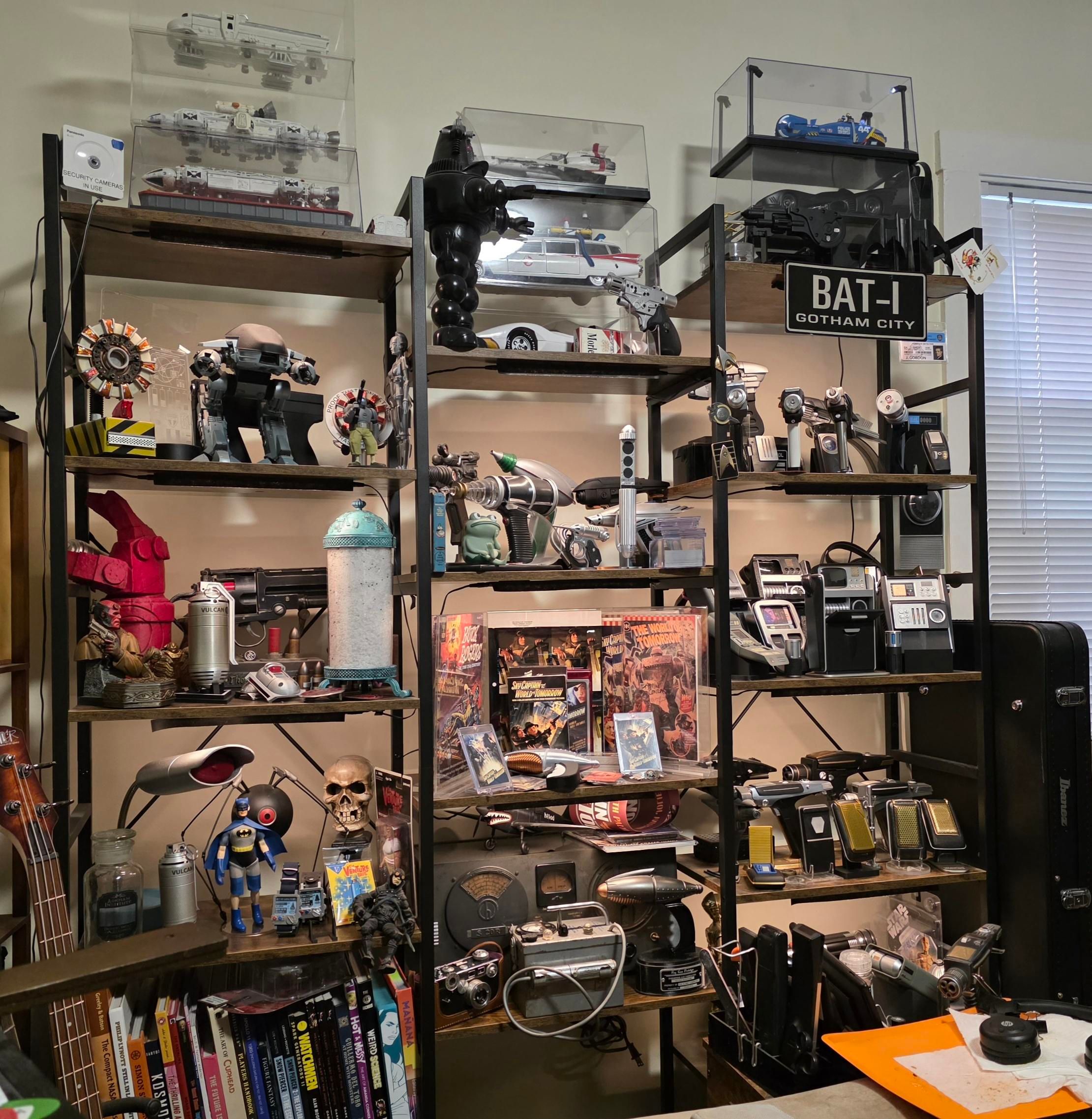 Shelves full of prop replicas, most sci-fi related but not all. There are a lot of fictional weapons, ships as well as stuff from Hellboy and venture Bros