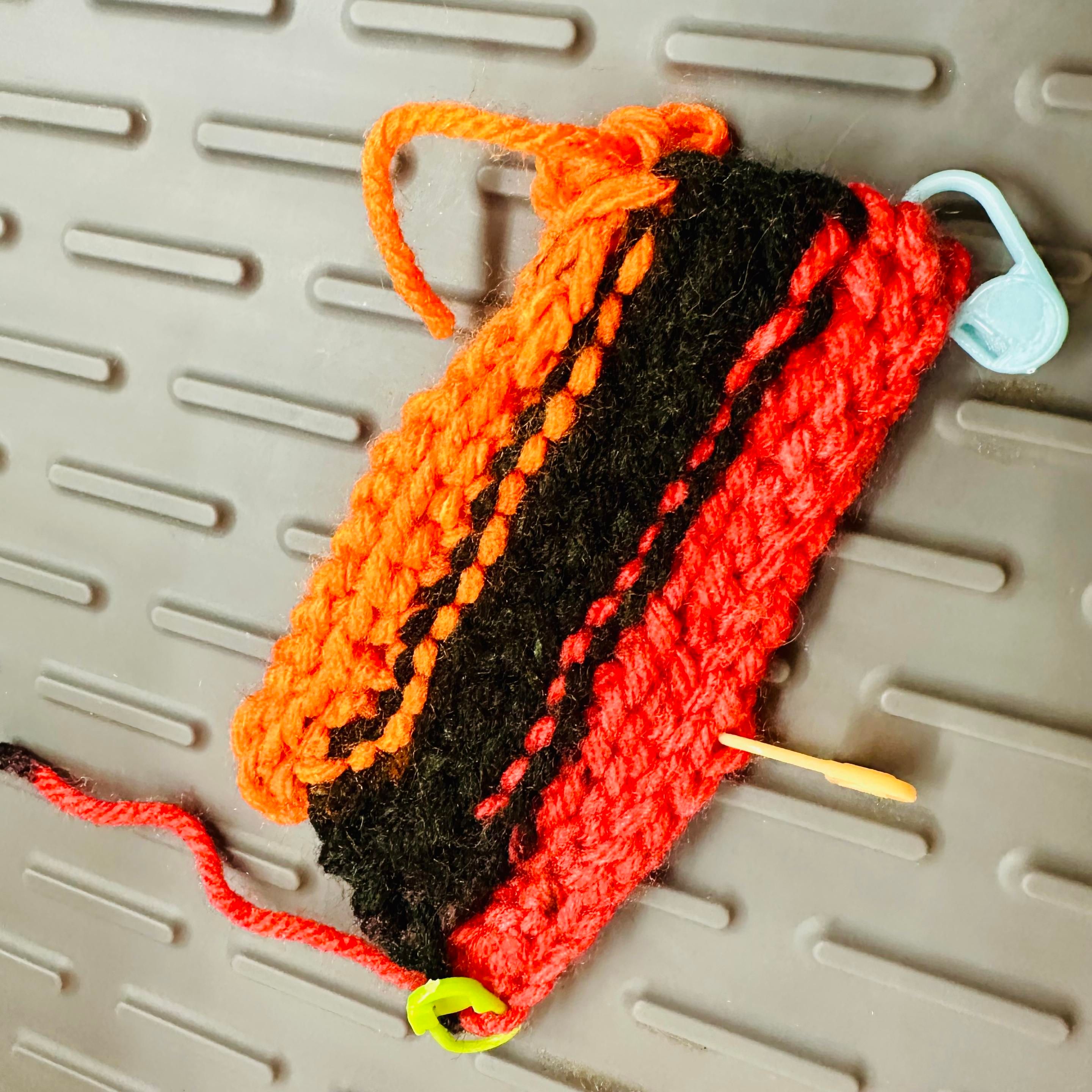 A photo of a small piece of crochet work with various slip stifches