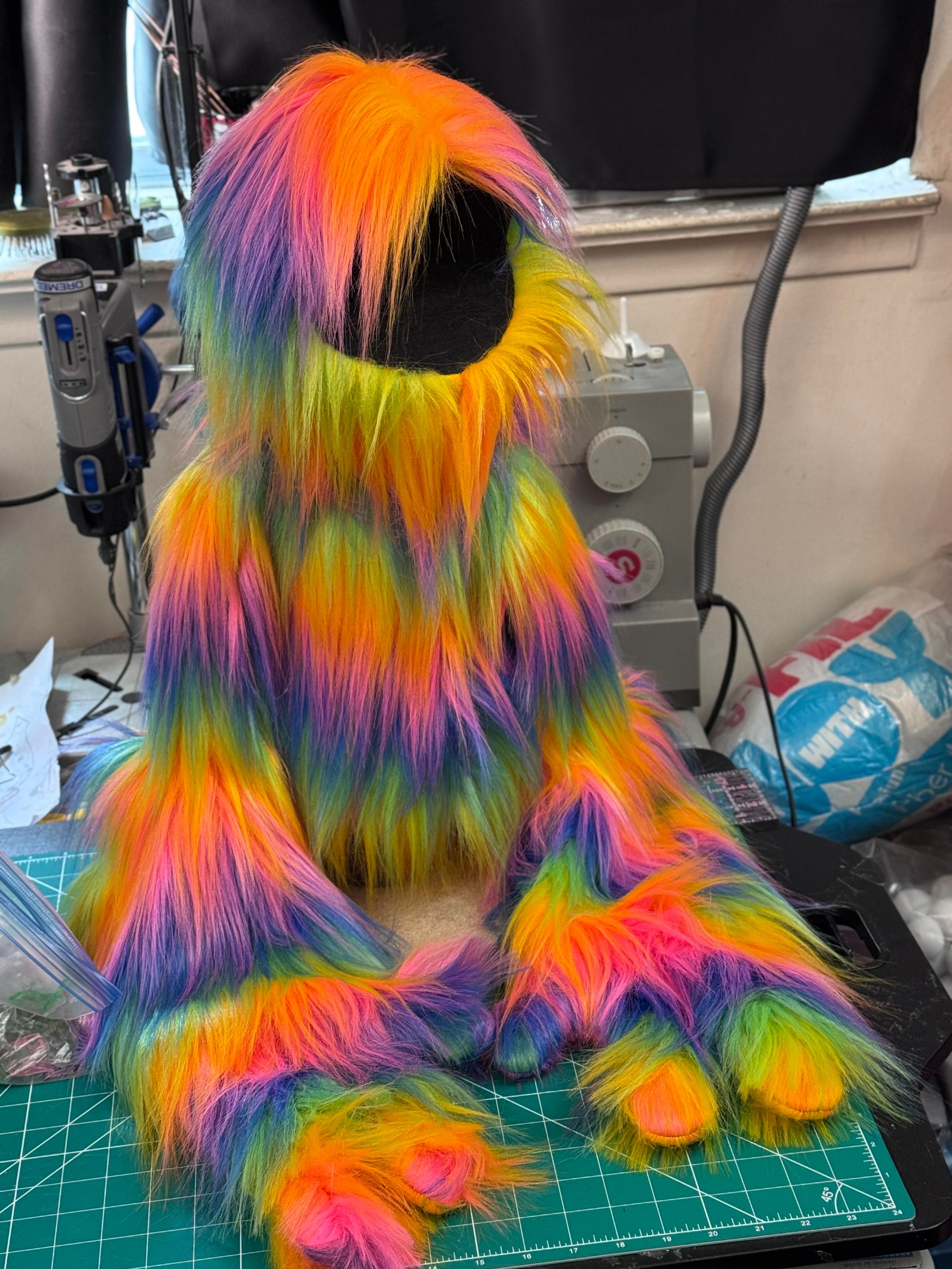 An unfinished live hands monster puppet with rainbow fur
