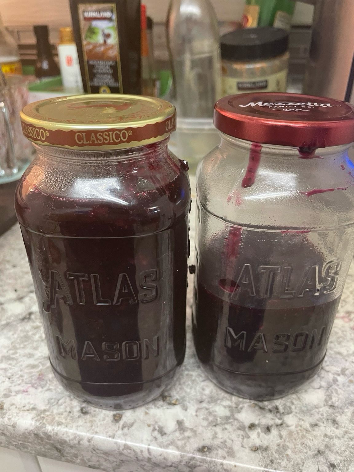 2 pint jars of blueberry jam. One is only half full 