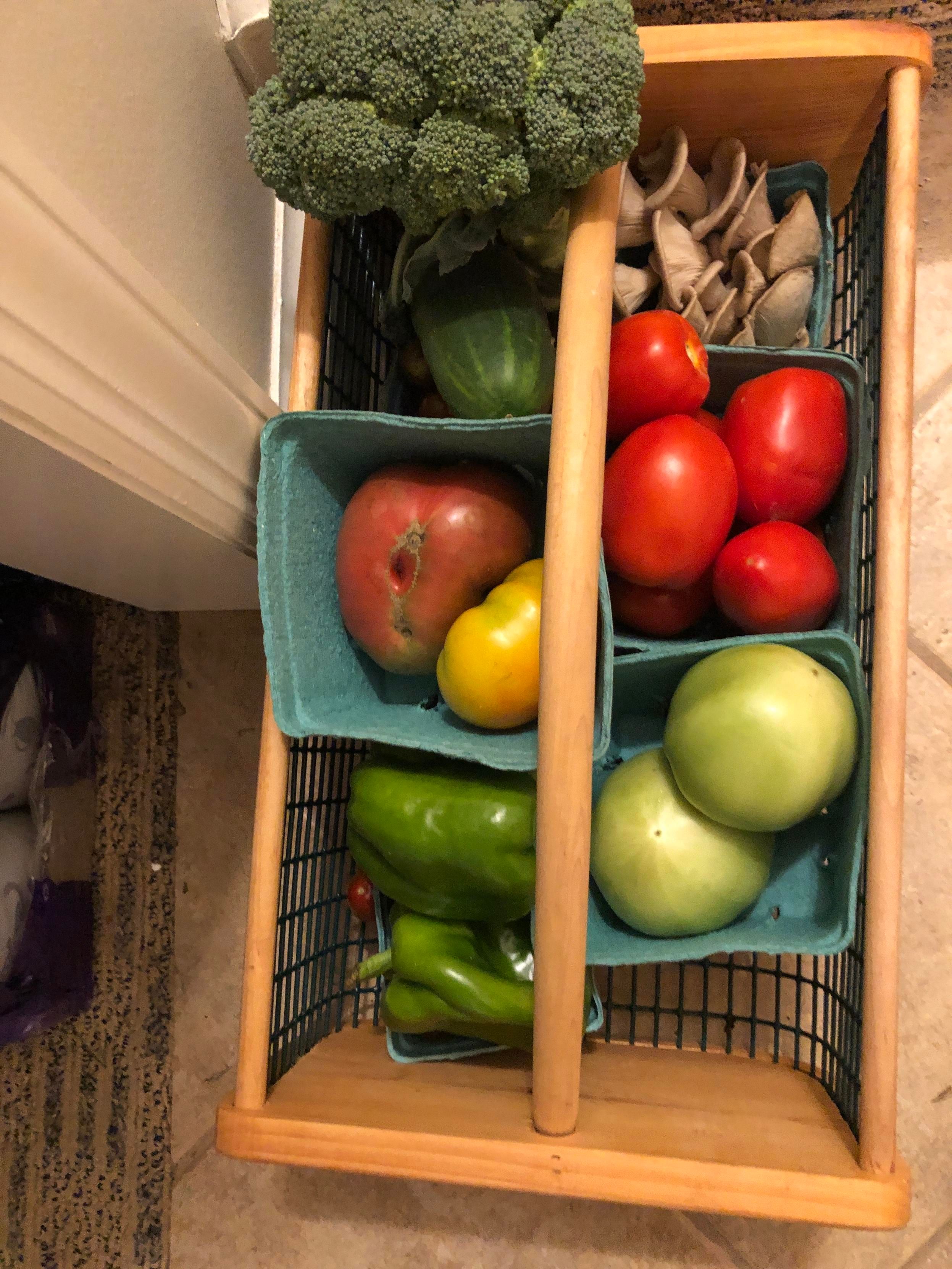 Sue's farm share basket that her husband got her for her birthday with cucumber, broccolli, mushrooms, roma tomatoes, green tomatoes, heirloom tomatoes, and green peppers
