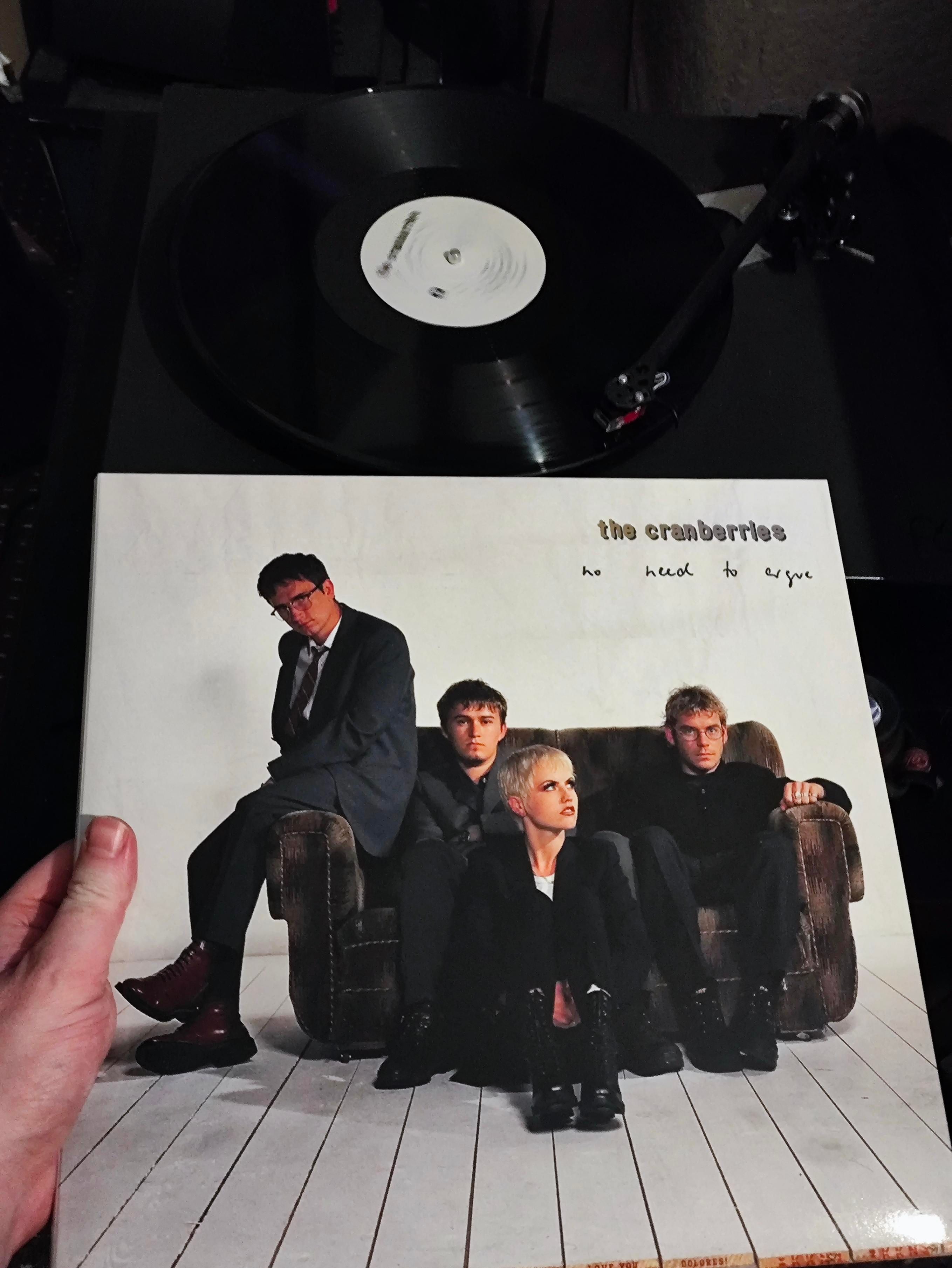 Members of the Band sat on or around a small sofa vinyl cover photo 