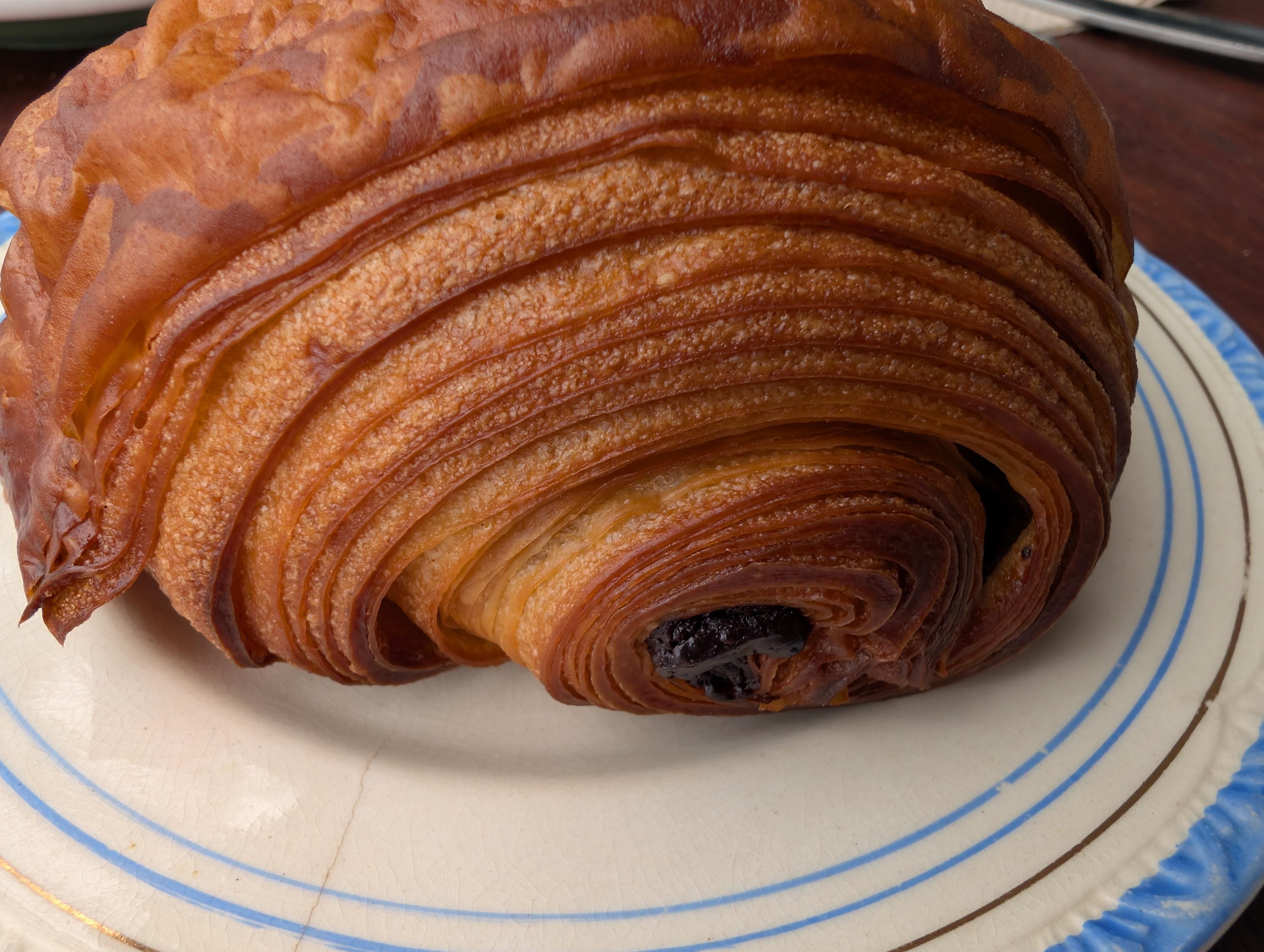 The end hole of a chocolate croissant showing hundreds of layers