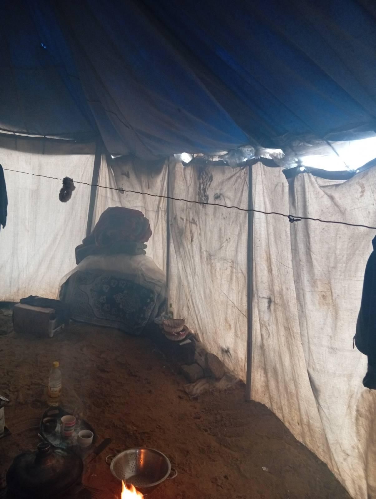 Our belongings on the wet sand under the tent