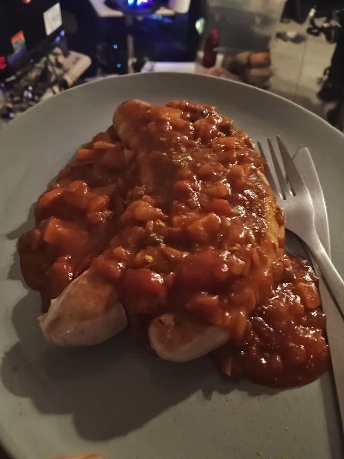 Closeup of Currywurst on a plate.