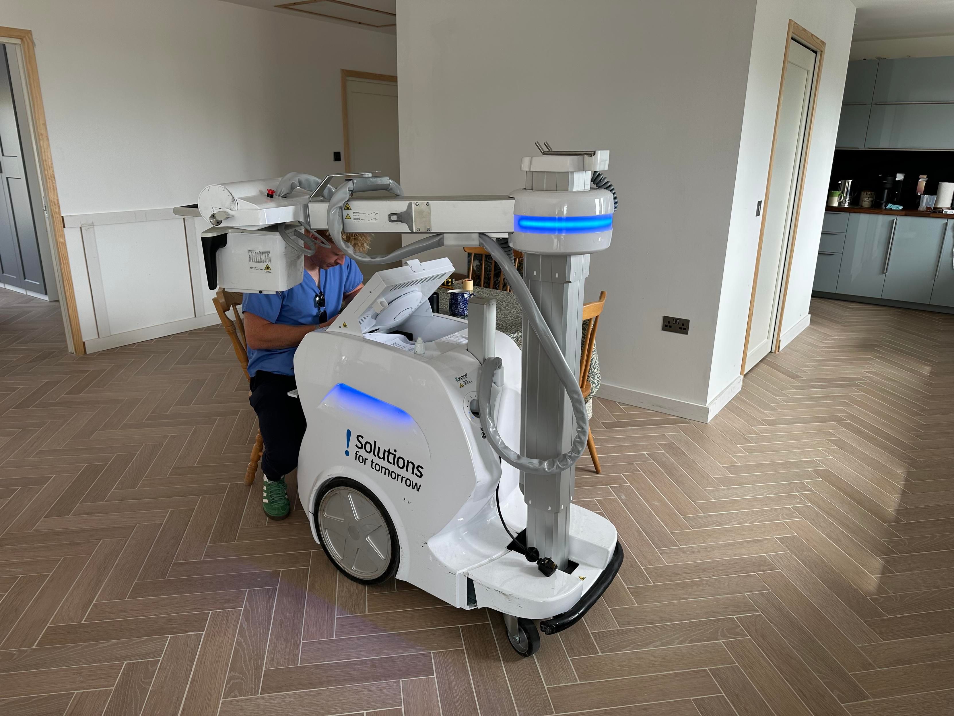 A portable X-ray machine. In my kitchen. About the size of a road sweeper cart but shiny white plastic. 