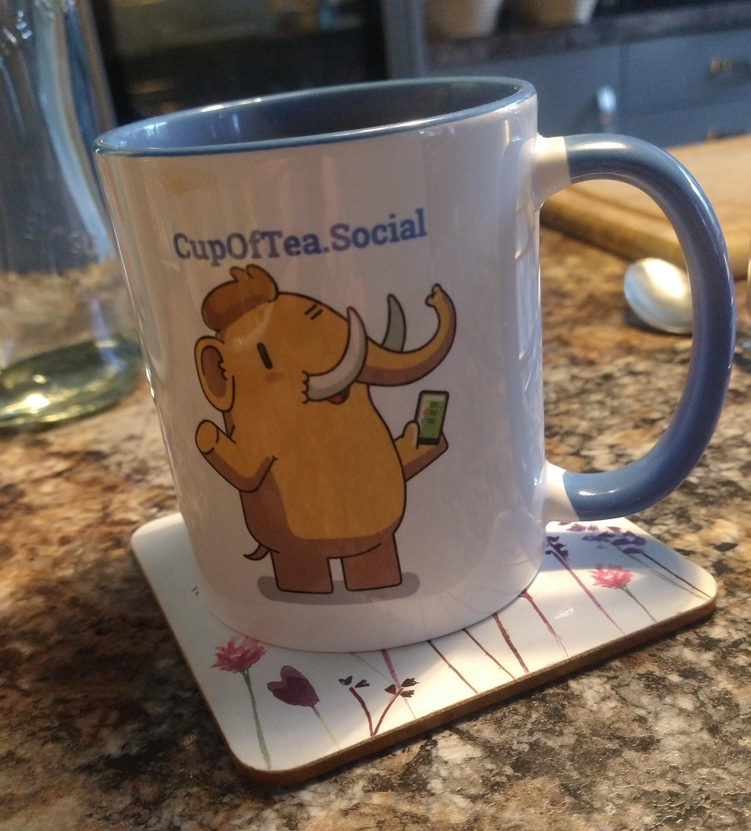 Blue cupofteasocial mug on a kitchen countertop 