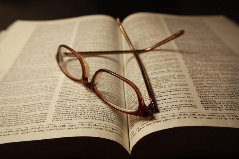 Reading glasses on top of an open dictionary