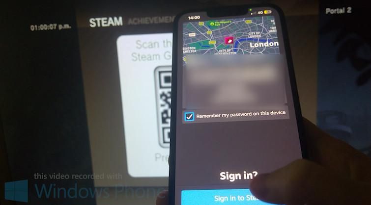 picture of an iPhone being held in front of a TV screen. the TV screen shows Steam on the PS3 showing a QR code and the phone in front shows a Steam Guard authentication prompt