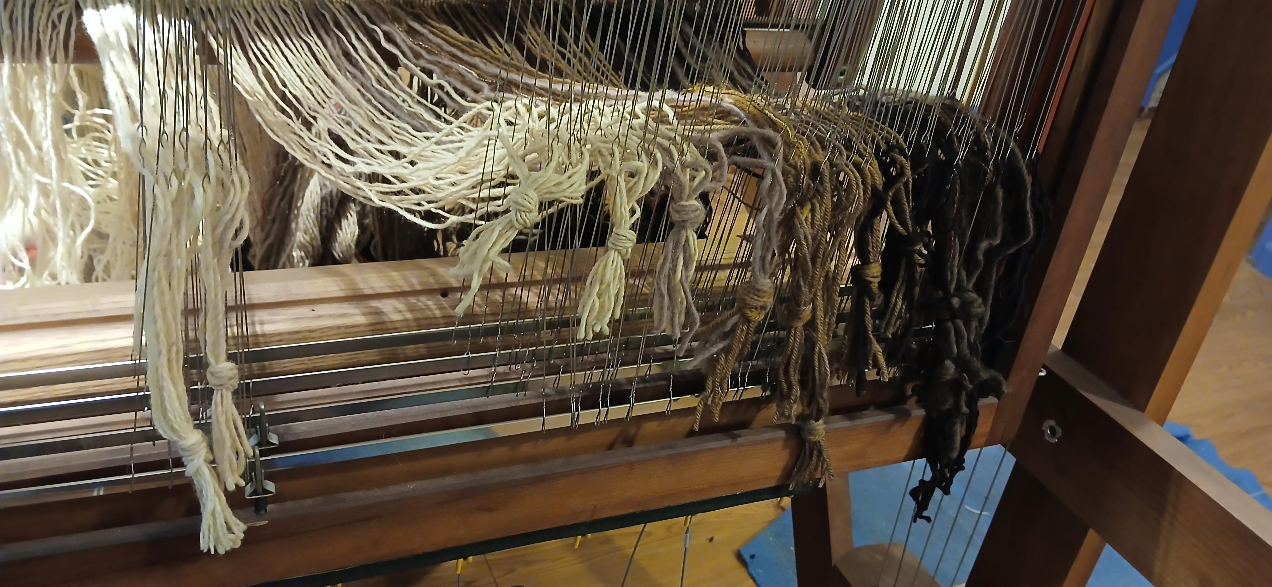 Warp spindle side of the heddle frames halfway warped with the hanks tied.