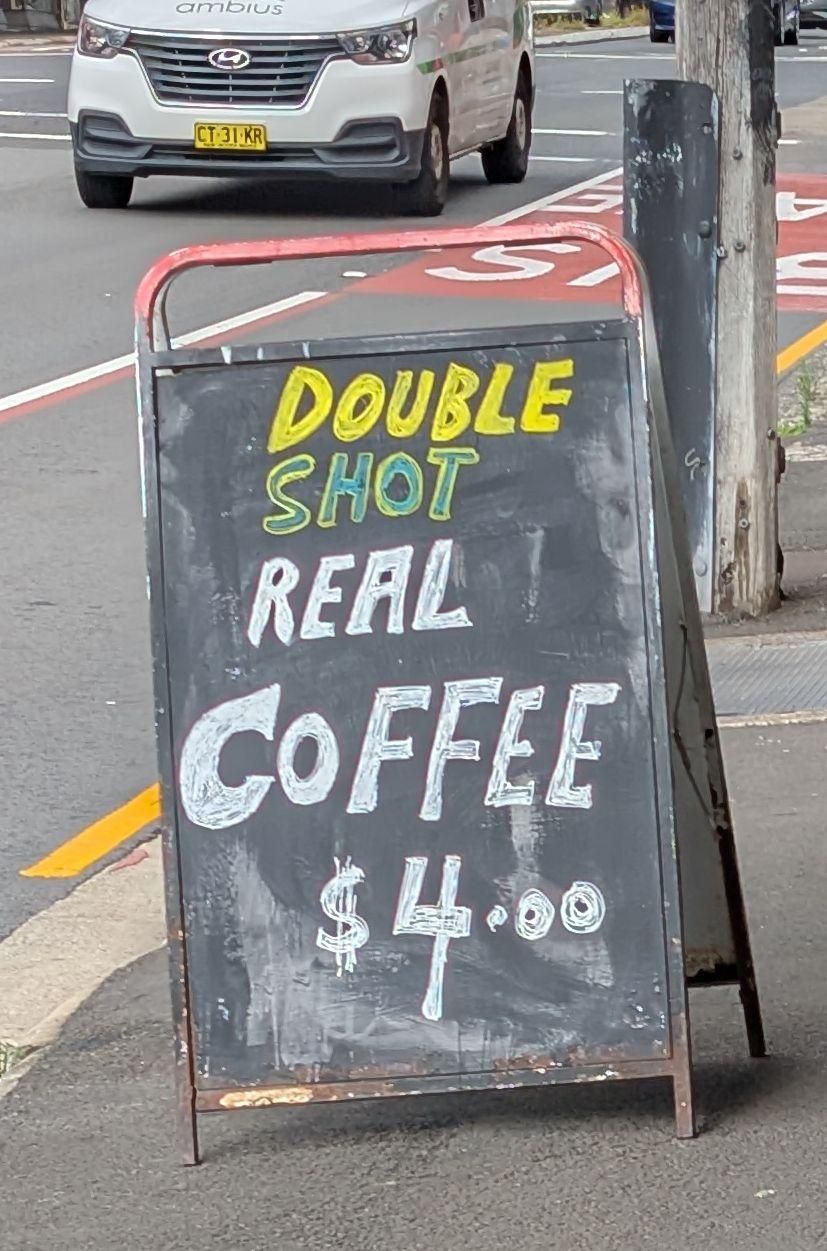 DOUBLE (in yellow}
SHOT {outlined in yellow, filled with blue}
REAL {white}
CoFFEE {white}
$4.00 {white}