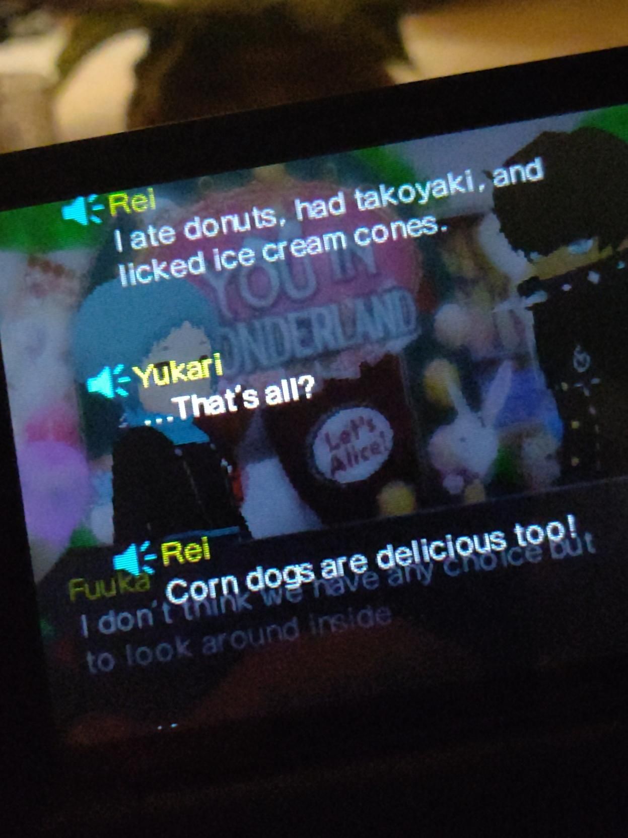 picture of Persona Q on my 2ds. rei has said, in front of The Labyrinth:
"i ate donuts, had takoyaki, and licked ice cream cones!"
yukari: "that's all?"
rei: "corn dogs are delicious too!"