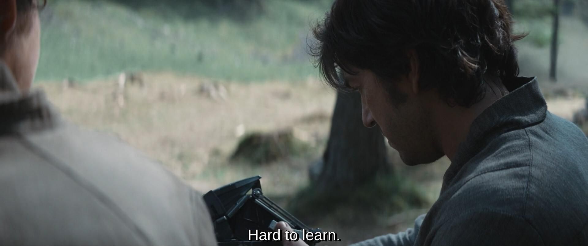 Cassian prend l’appareil en main et dit :
« hard to learn ».