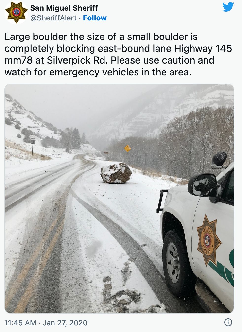 Pic of an old tweet by a sheriff's department with nonsensical text about a large boulder the size of a small boulder blocking a road, showing the paradoxical object in the snow