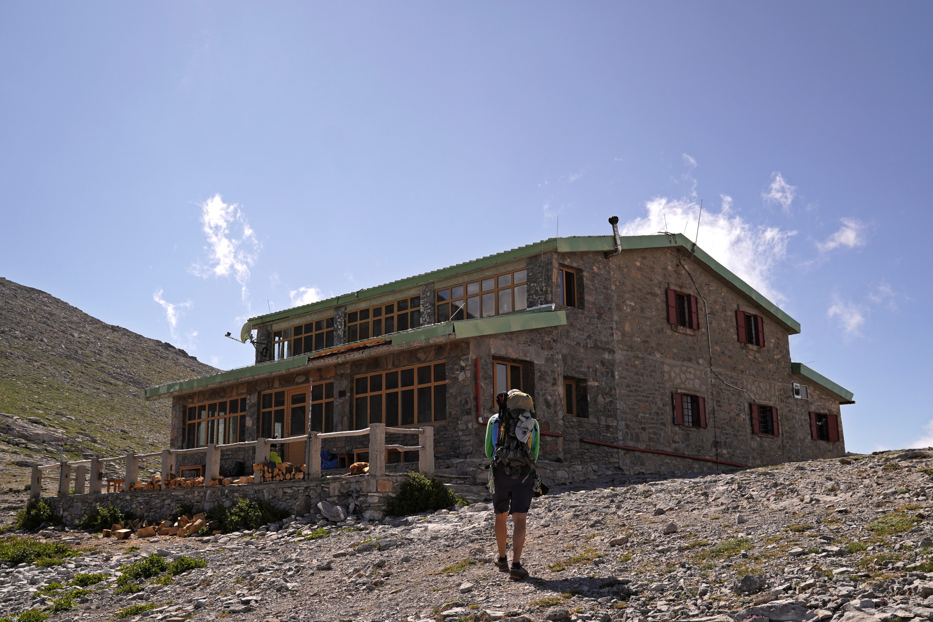 Approaching Apostolidis refuge, a two-storey building on the Olympus plateau with a generous verandah.