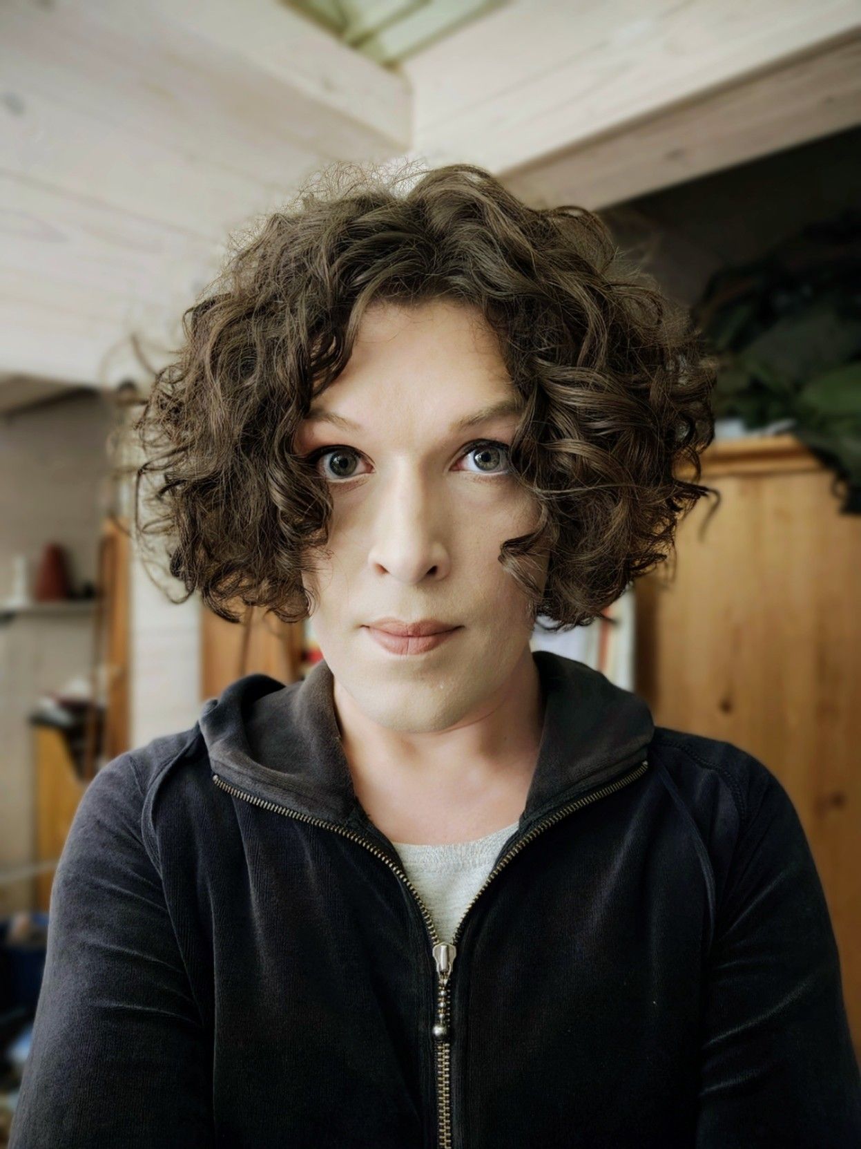 selfie indoors, wearing a hoodie with a zipper