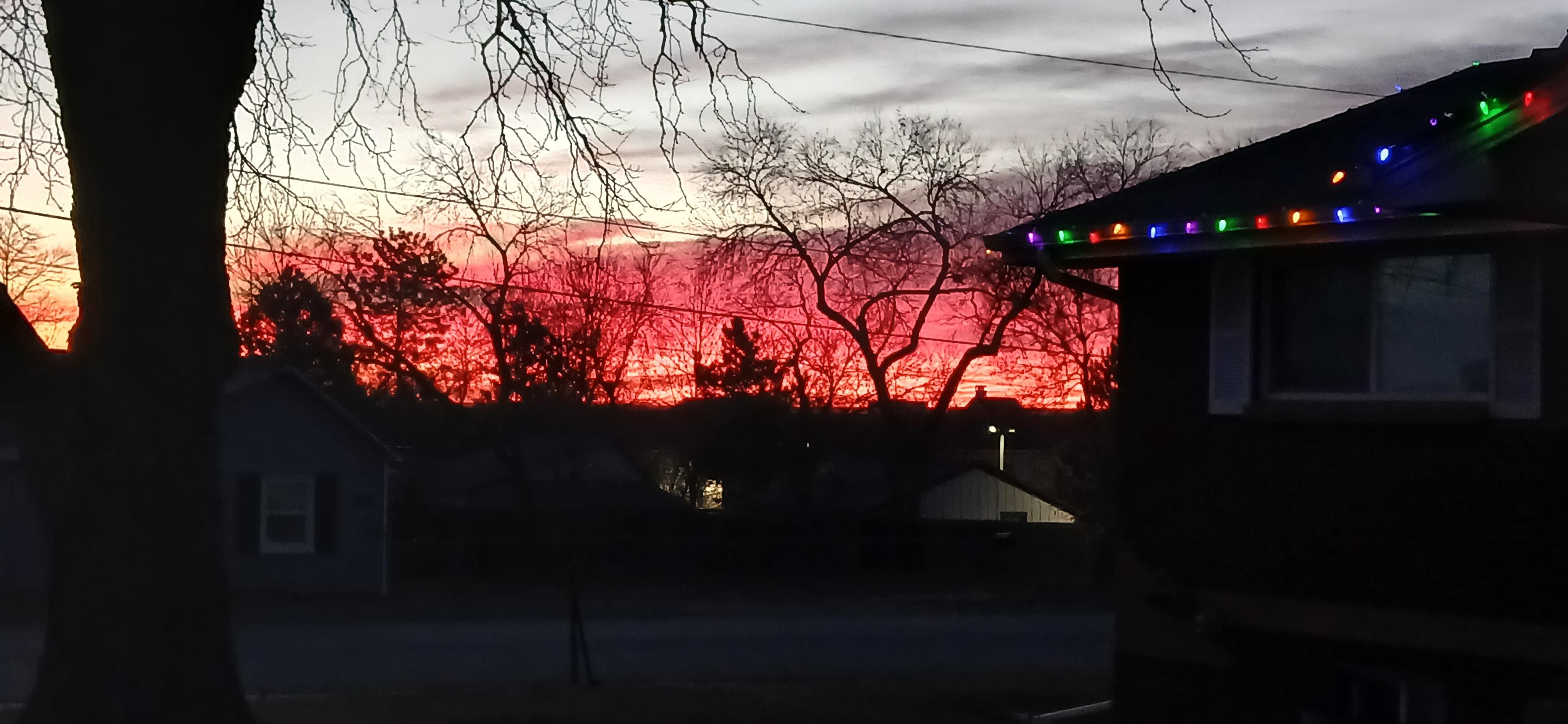 Red sunrise mostly thru trees