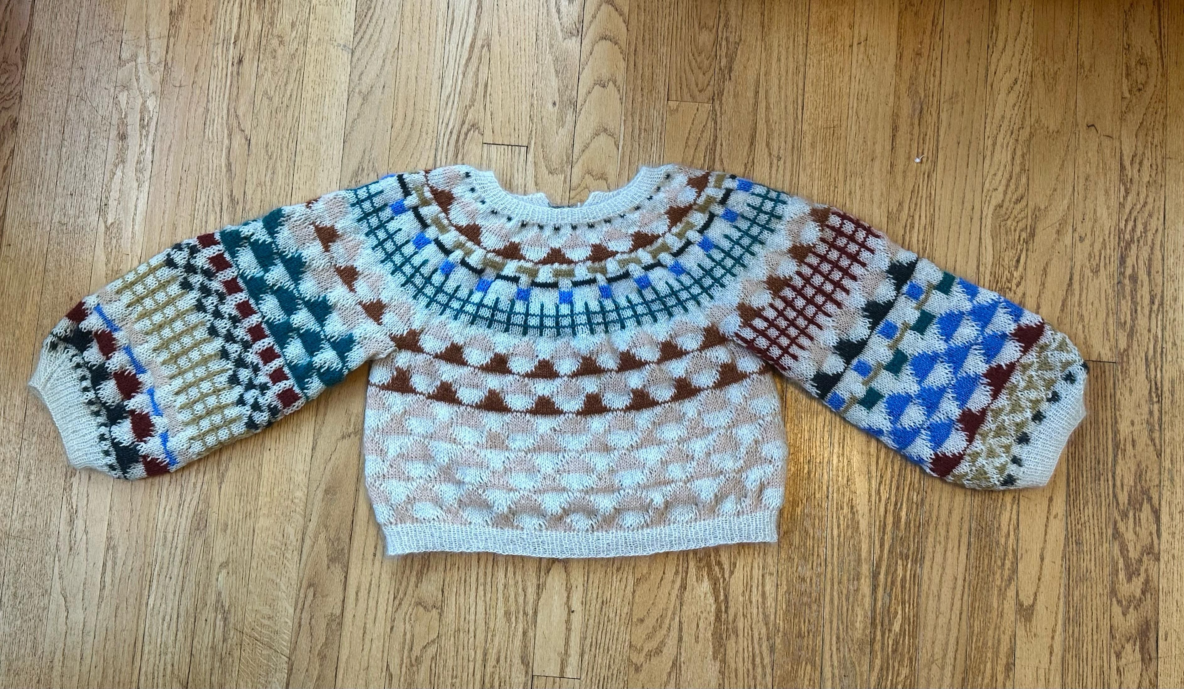 The “djo” pattern sweater. It has geometric motifs throughout in multiple colors of mohair and huge sleeves