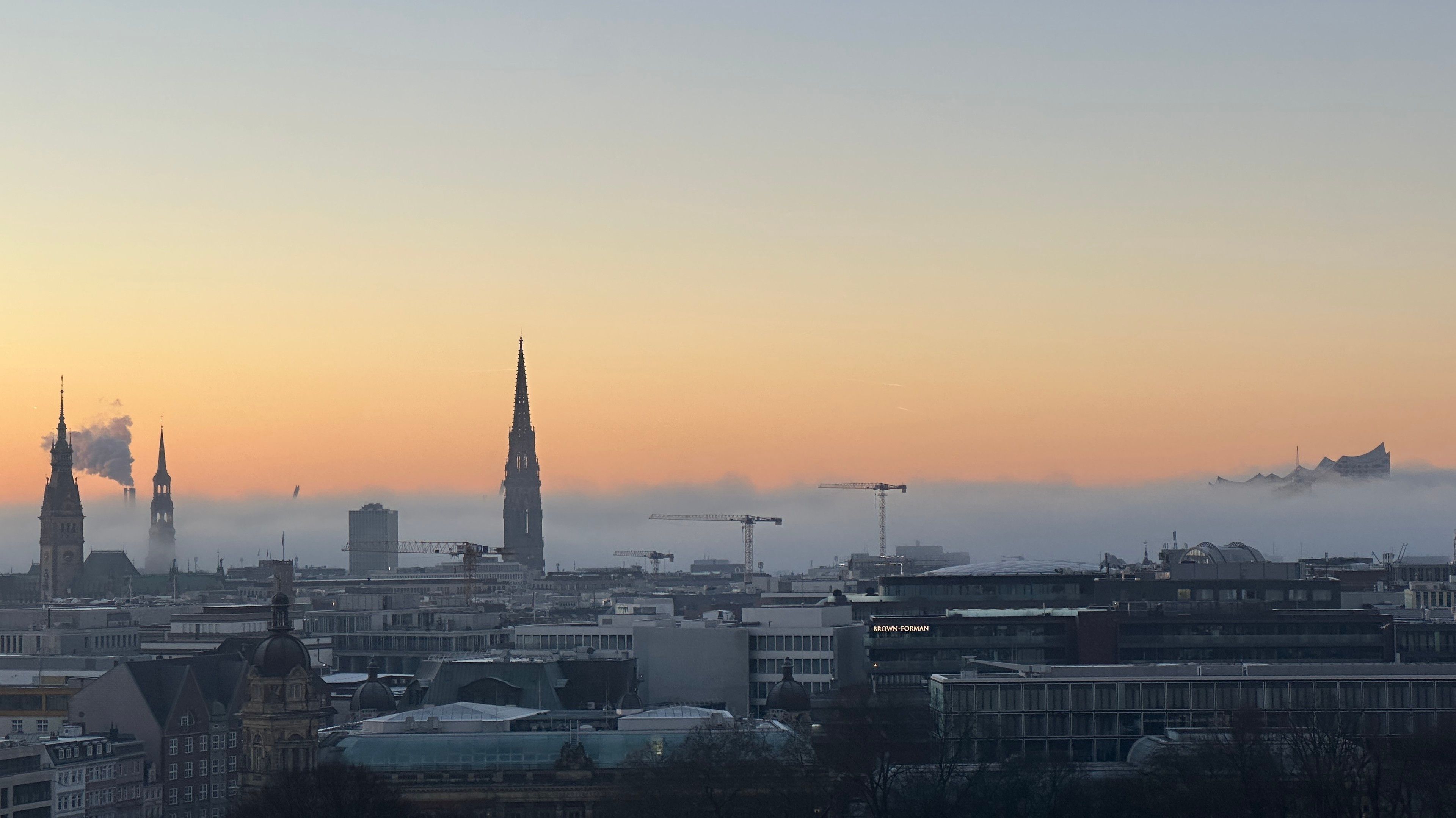 Clouds obscuring the city with church towers just above