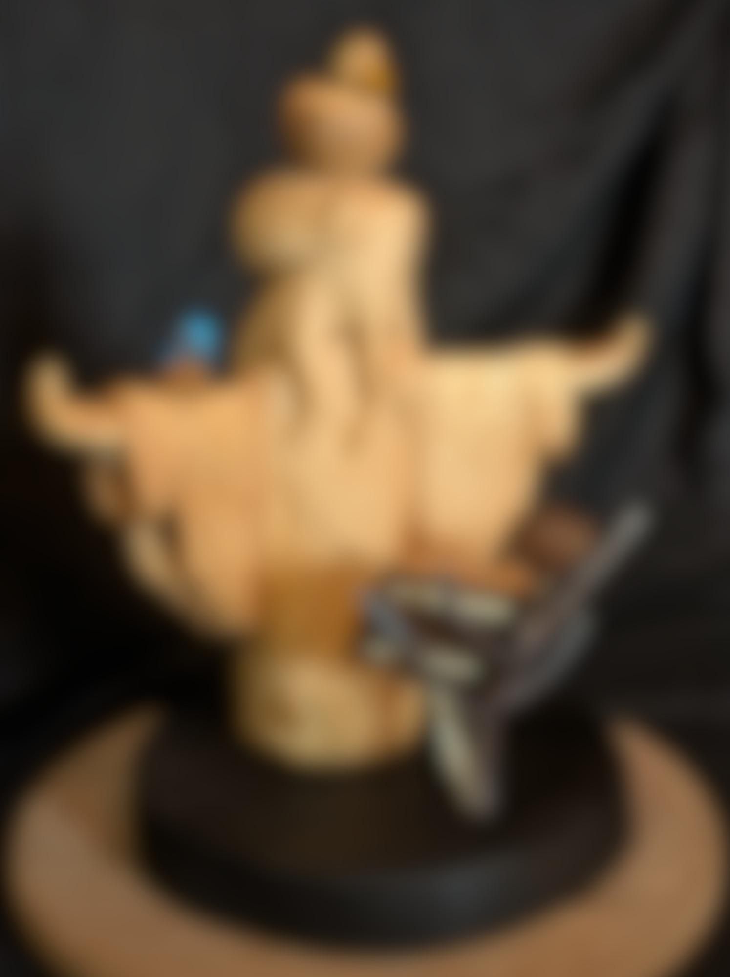 Blurry image of a woodcarved humanoid octopus wearing a dress
