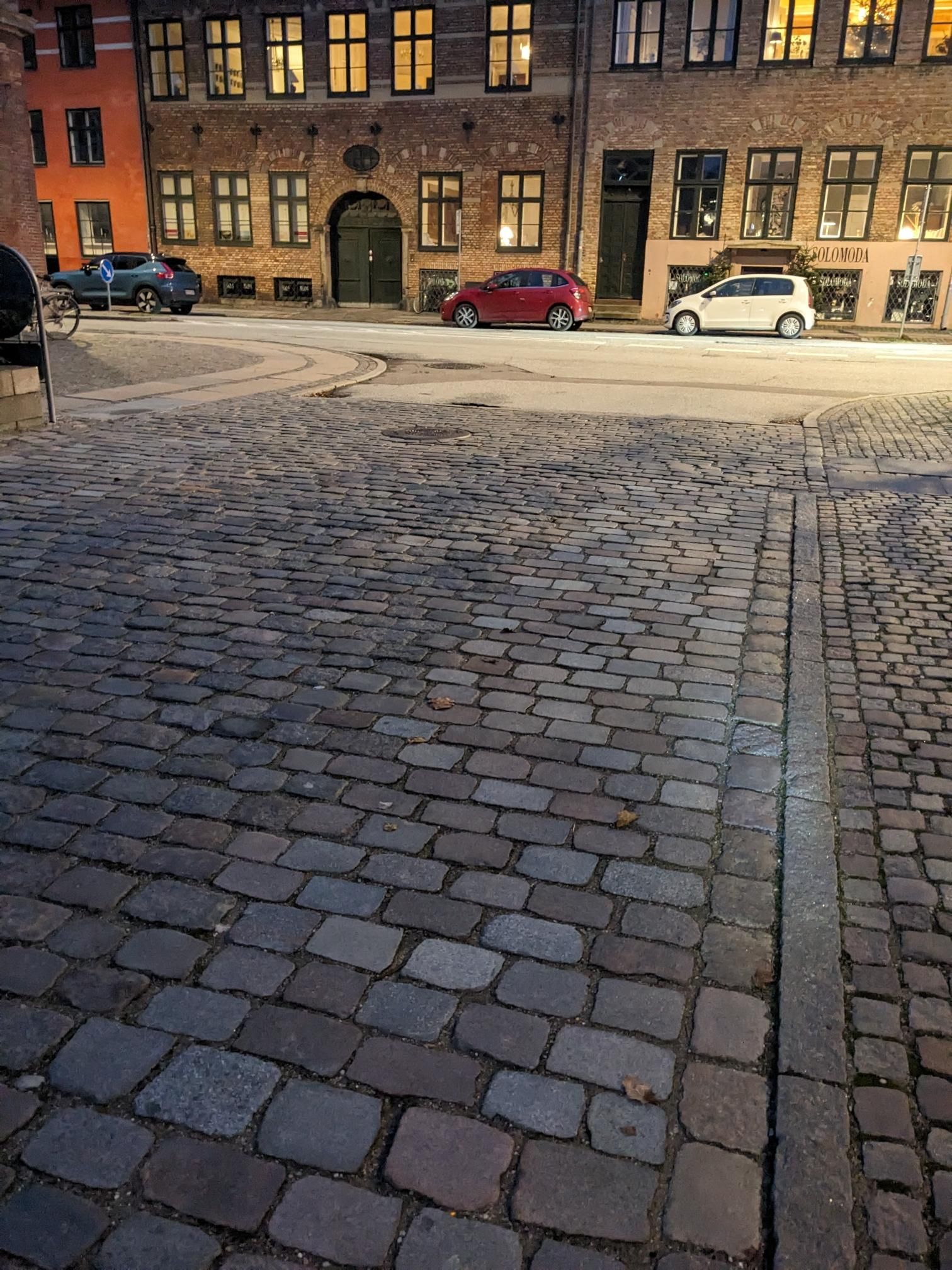 Photo of said street. The sides have smoother paving stones.