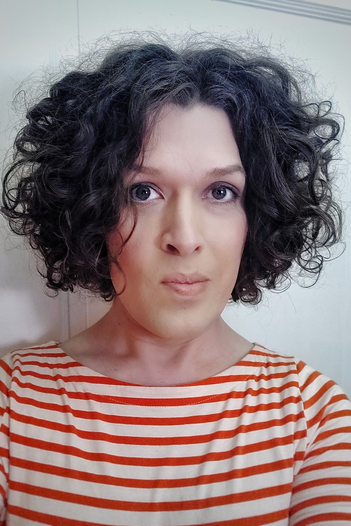 portrait selfie, me in a white and orange horisontally striped top