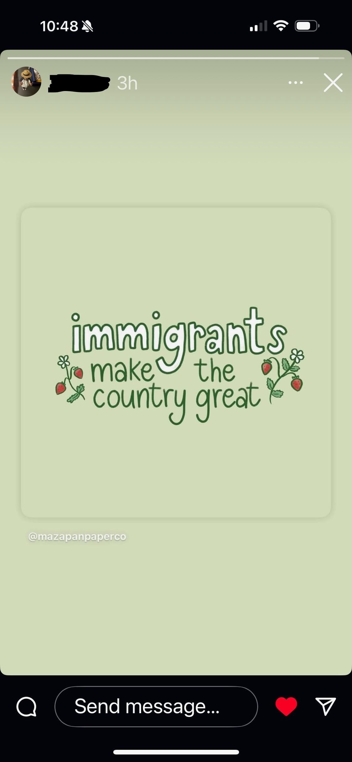A flowery message saying, "Immigrants make the country great" in white text on a pale green background, with flowers around the words.