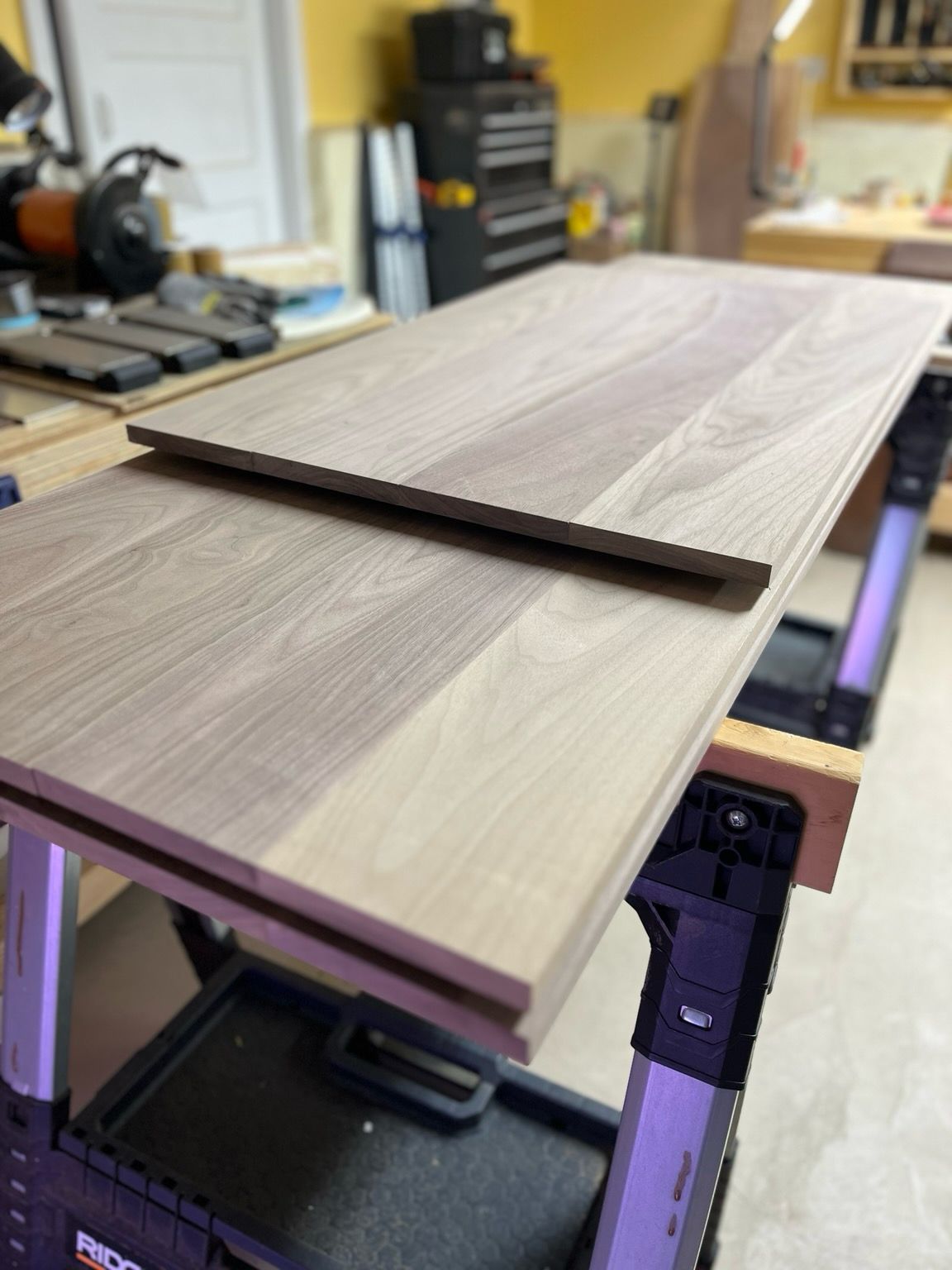 Stacked panels of walnut wood  smooth and flat.