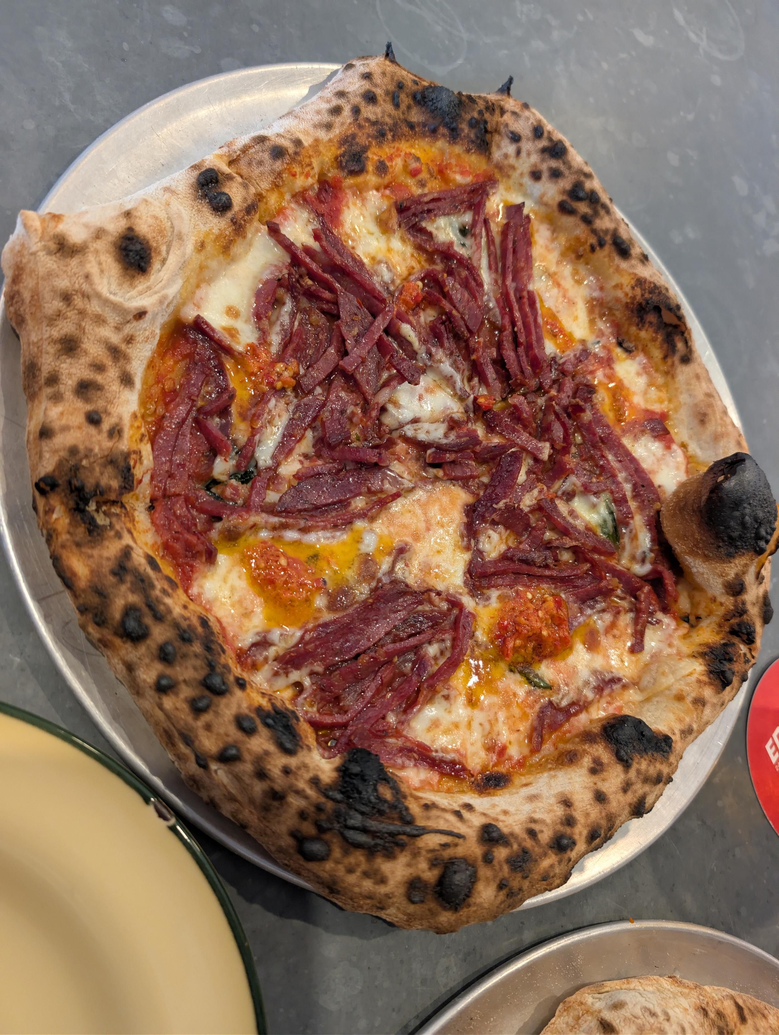 Meat and chilli sauce wood fire pizza