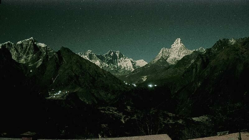 A green-tinted night-time webcam shot of a mountain ridge. Above the mountains is a clear view of a night sky filled with stars.

Mountains in the view, from left:

- Taboche (6,500 meters/21,325 feet)
- Mount Everest (8,848 meters/29,032 feet)
- Lhotse (8,516 meters/27,939 feet)
- Ama Dablam (6,814 meters/22,355 feet)