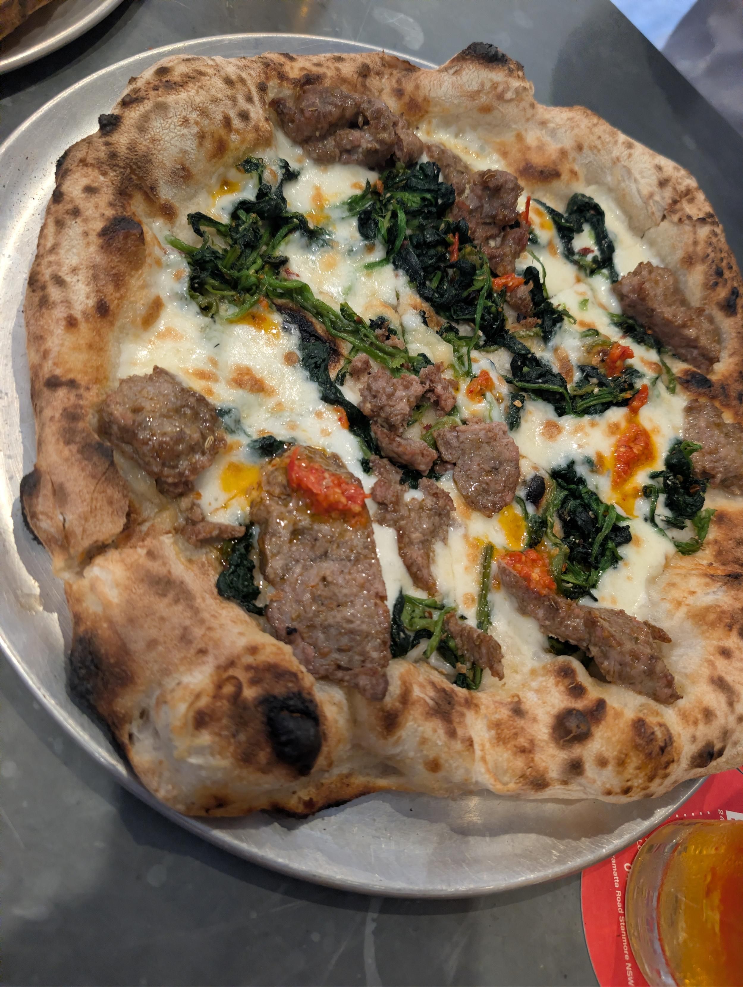 A meat pizza wood fired