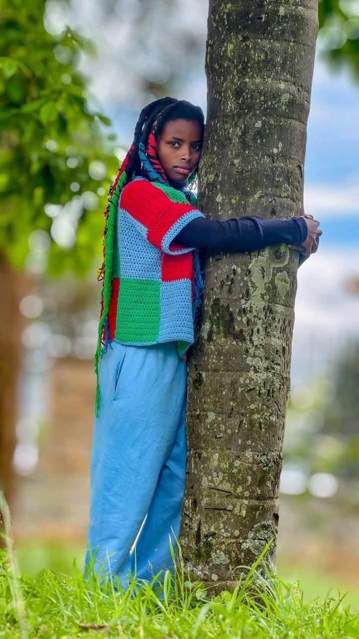 Truphena Muthoni holding an indigenous tree for 72 hours. 