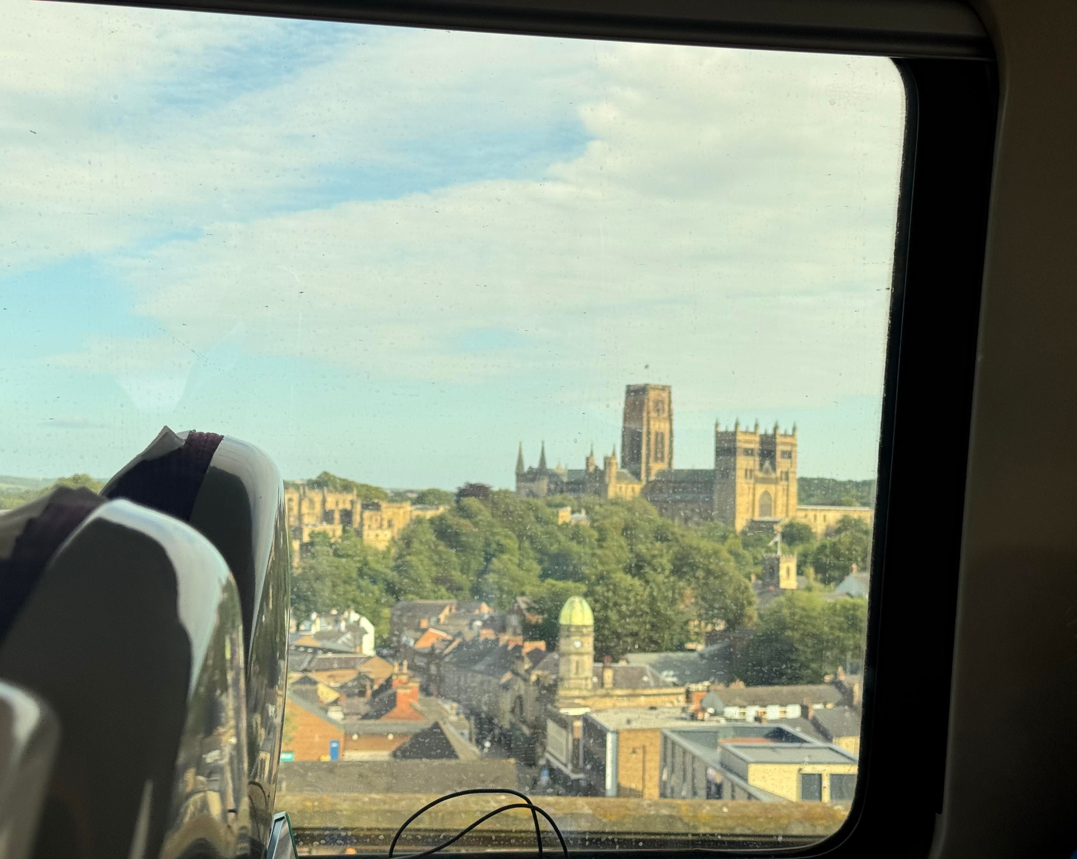 A view of Durham cathedral through a train window.