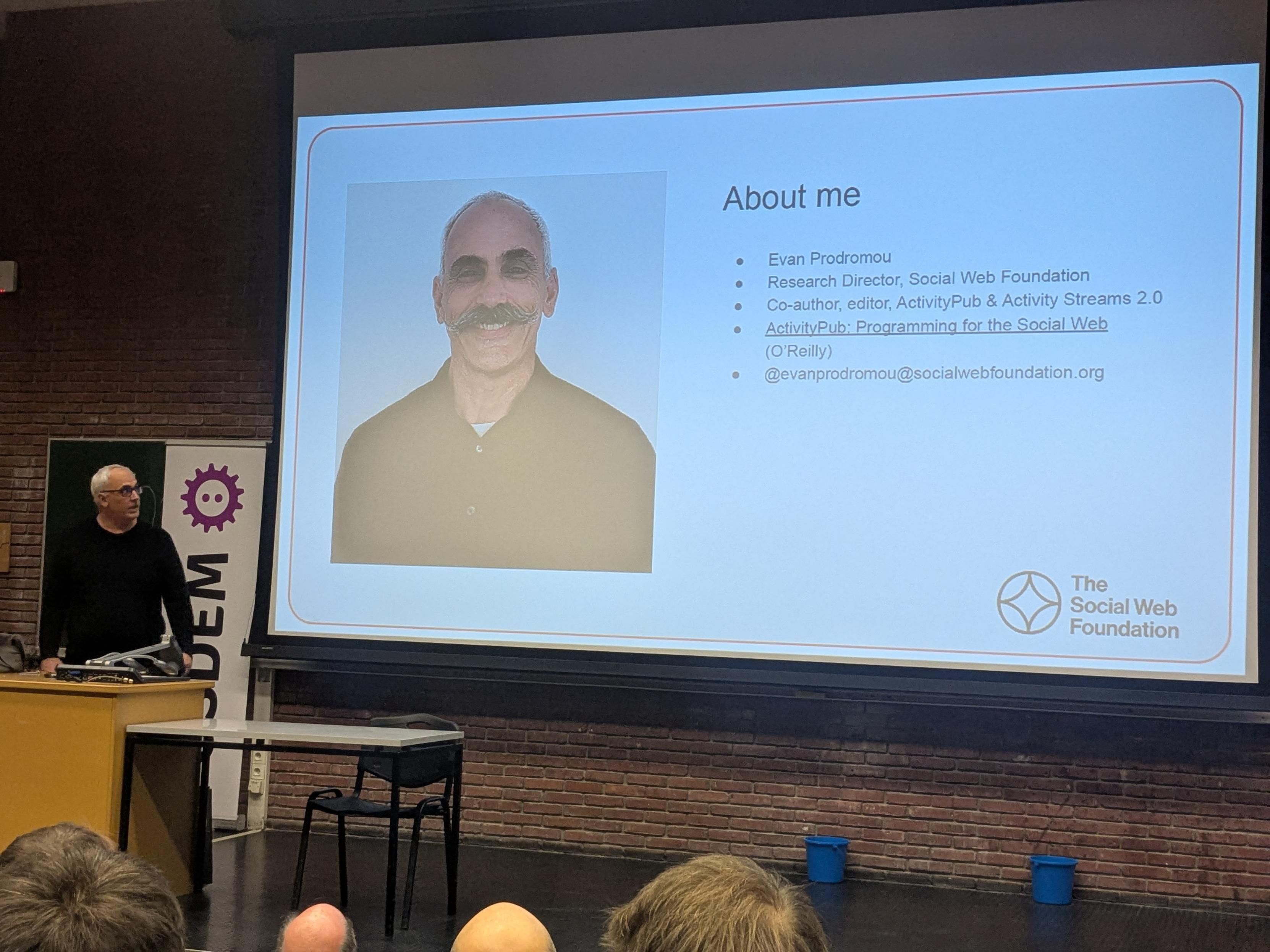 a slide with a moustached man with a clean shaven man next to it.