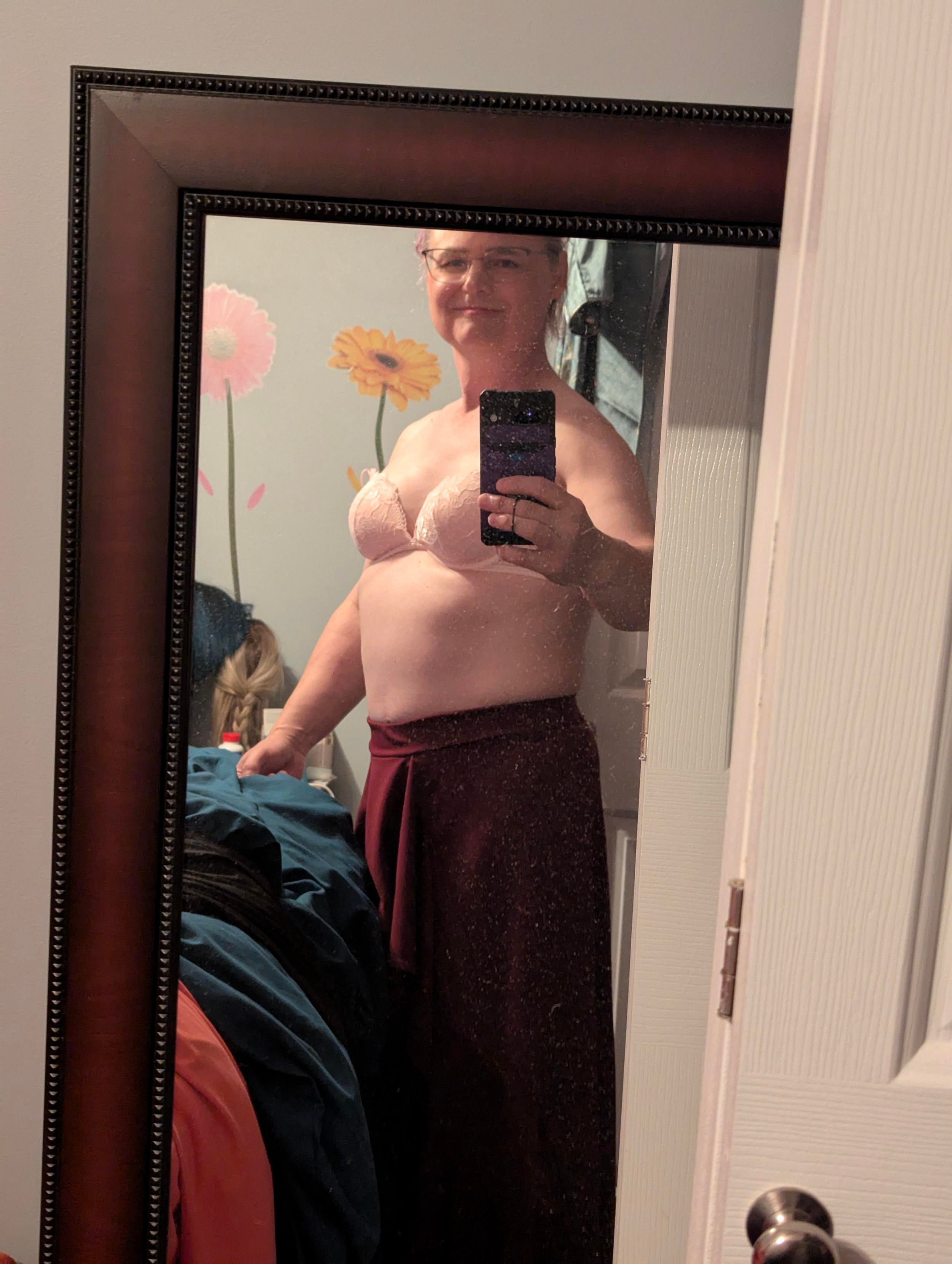 A selfie in my bedroom mirror, wearing a long burgundy skirt and a light push up bra. I almost have abs. I definitely have boobs.