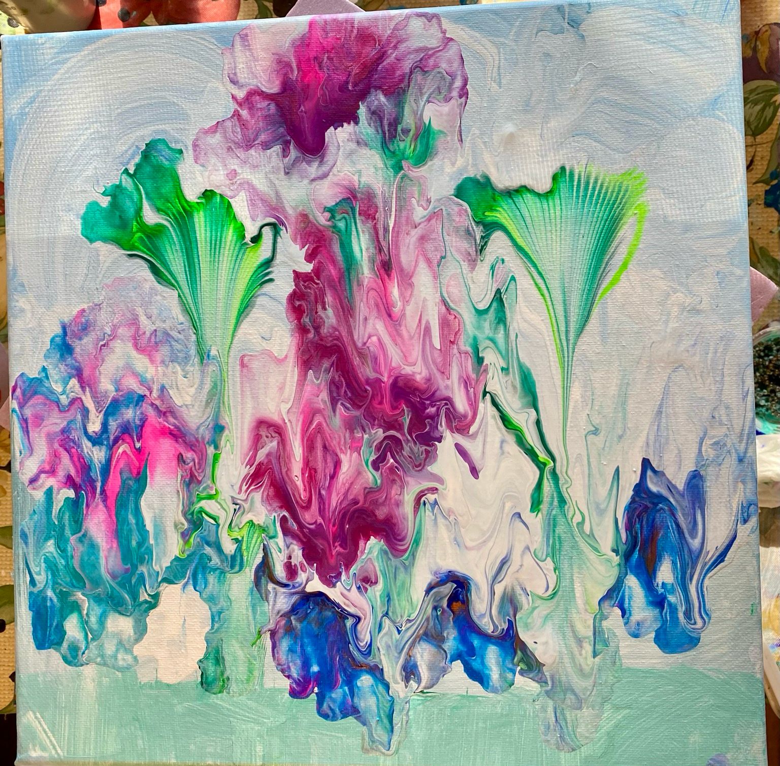 Cacophonous riot of colors, just higgeldy piggeldy all over the place. There are shades of green, blues, turquoise, many shades of pinks and purples with a background of swirling white and blue. It’s very colorful, but I’m not sure it says anything other than chaos ruled this studio today. 