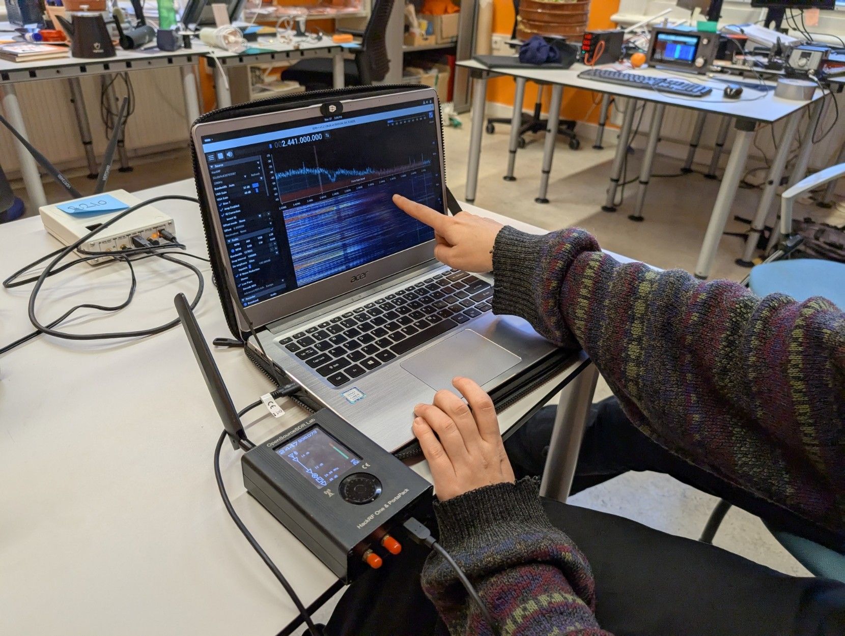 An “OpenSourceSDR Lab” connected to Chris’ laptop, with SDR++ open at 2.4GHz