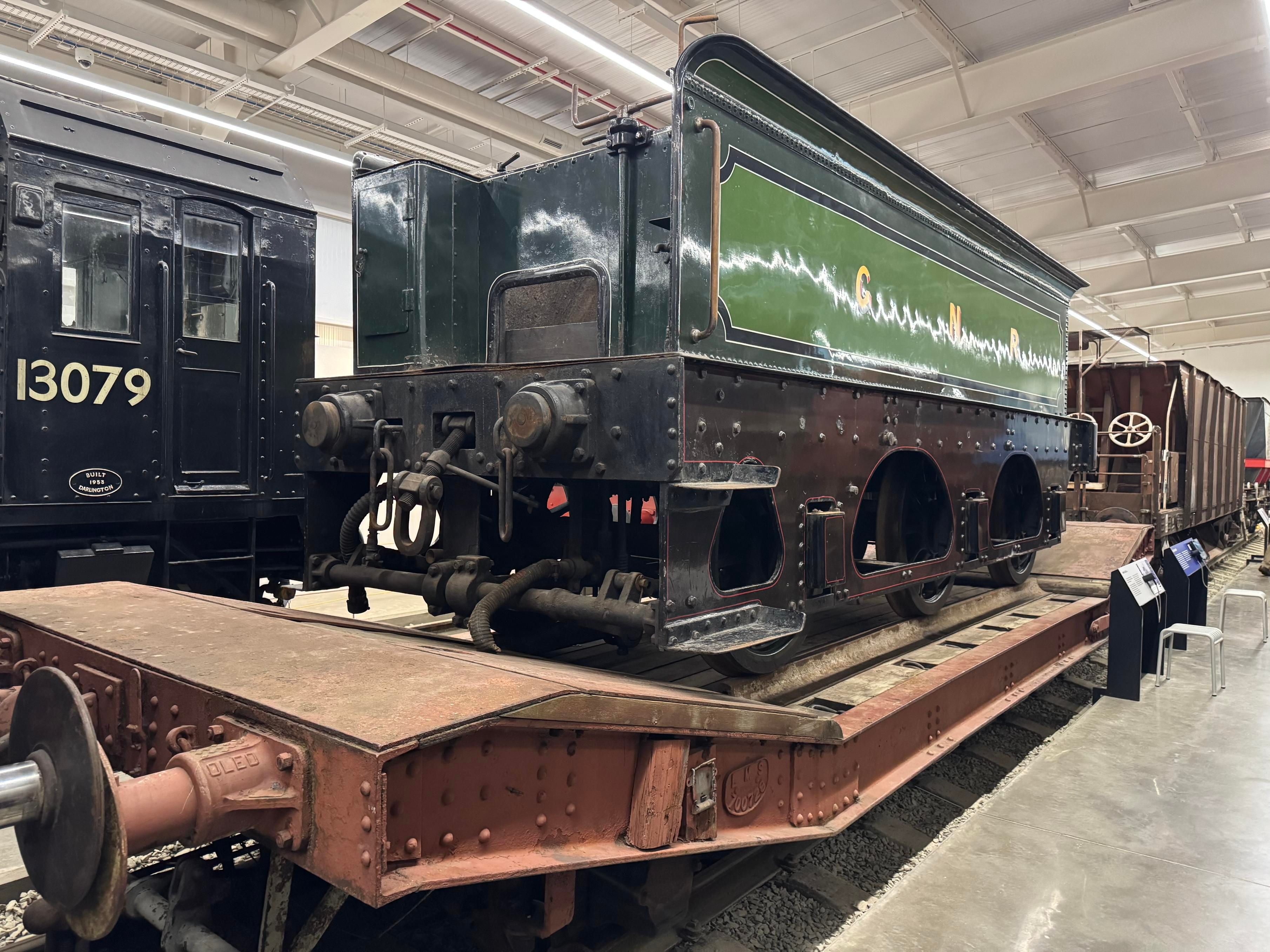 A 1944 Lowmac wagon carrying a Great Western Railway locomotive tender on some removable rails.