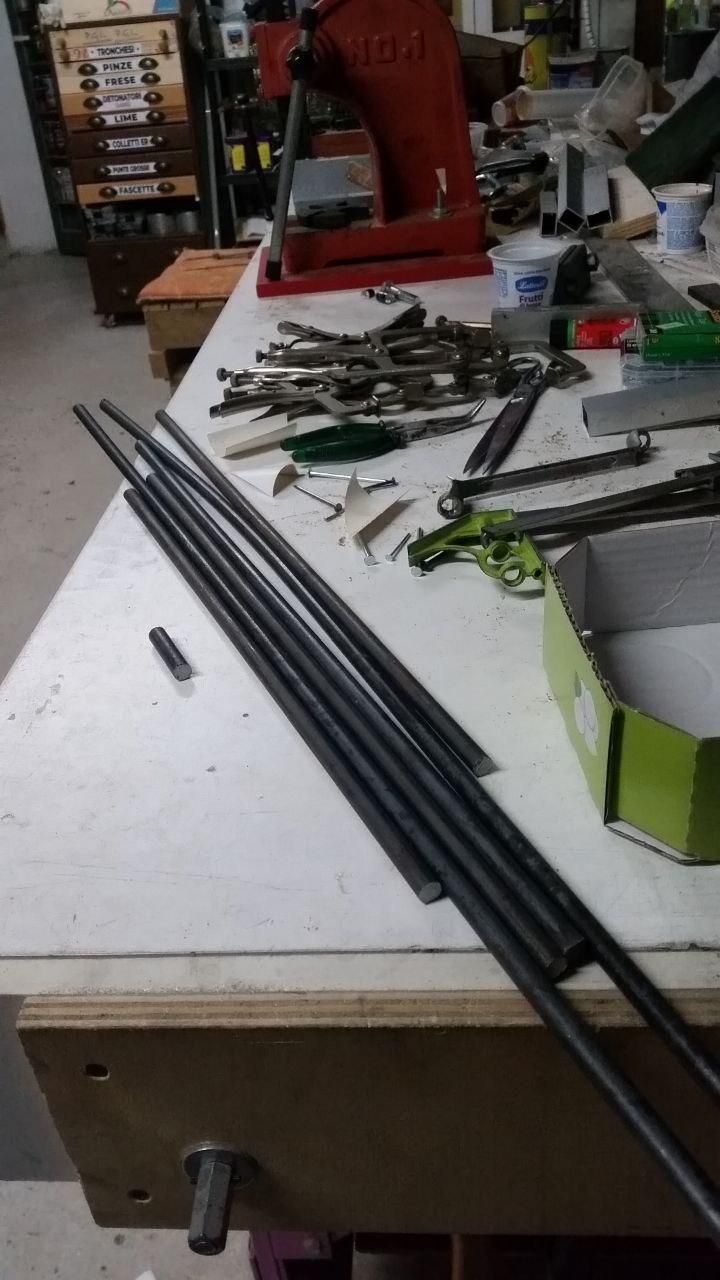 Angolo del tavolo con una manata di tondini di ferro liscio da 10 mm.
A sinistra della manata il pezzettino che mi sarebbe bastato.