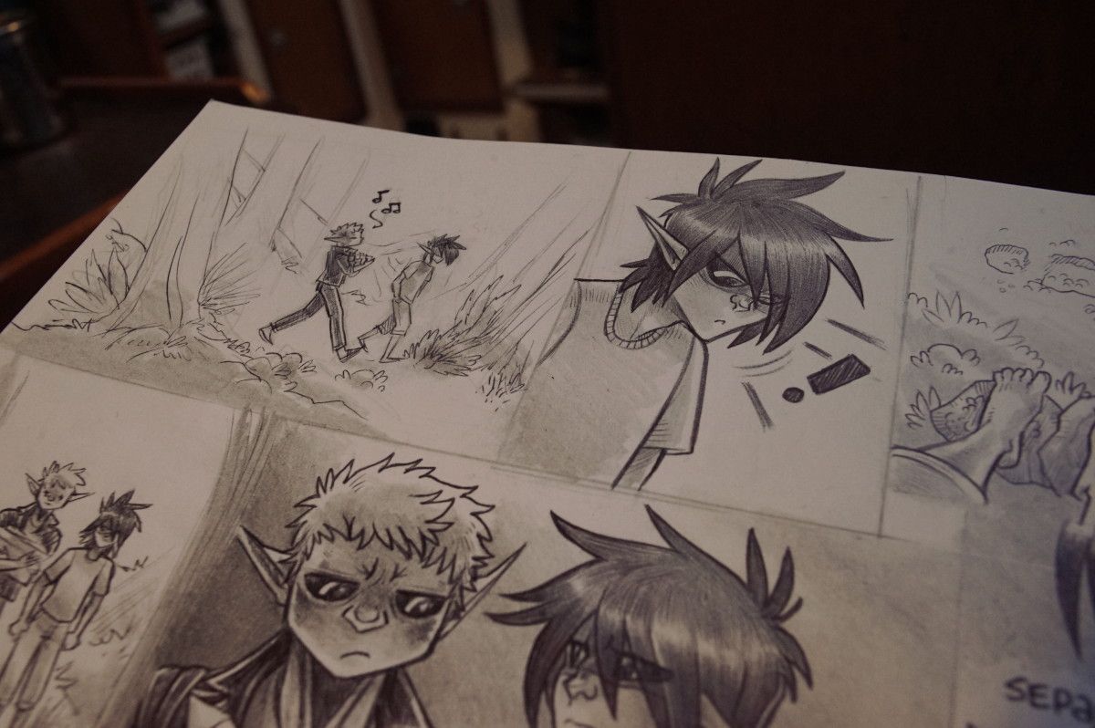 a photo of a sketchbook page, showing frames that are inked with a ball point pen and partially shaded with pencil(not yet finished)