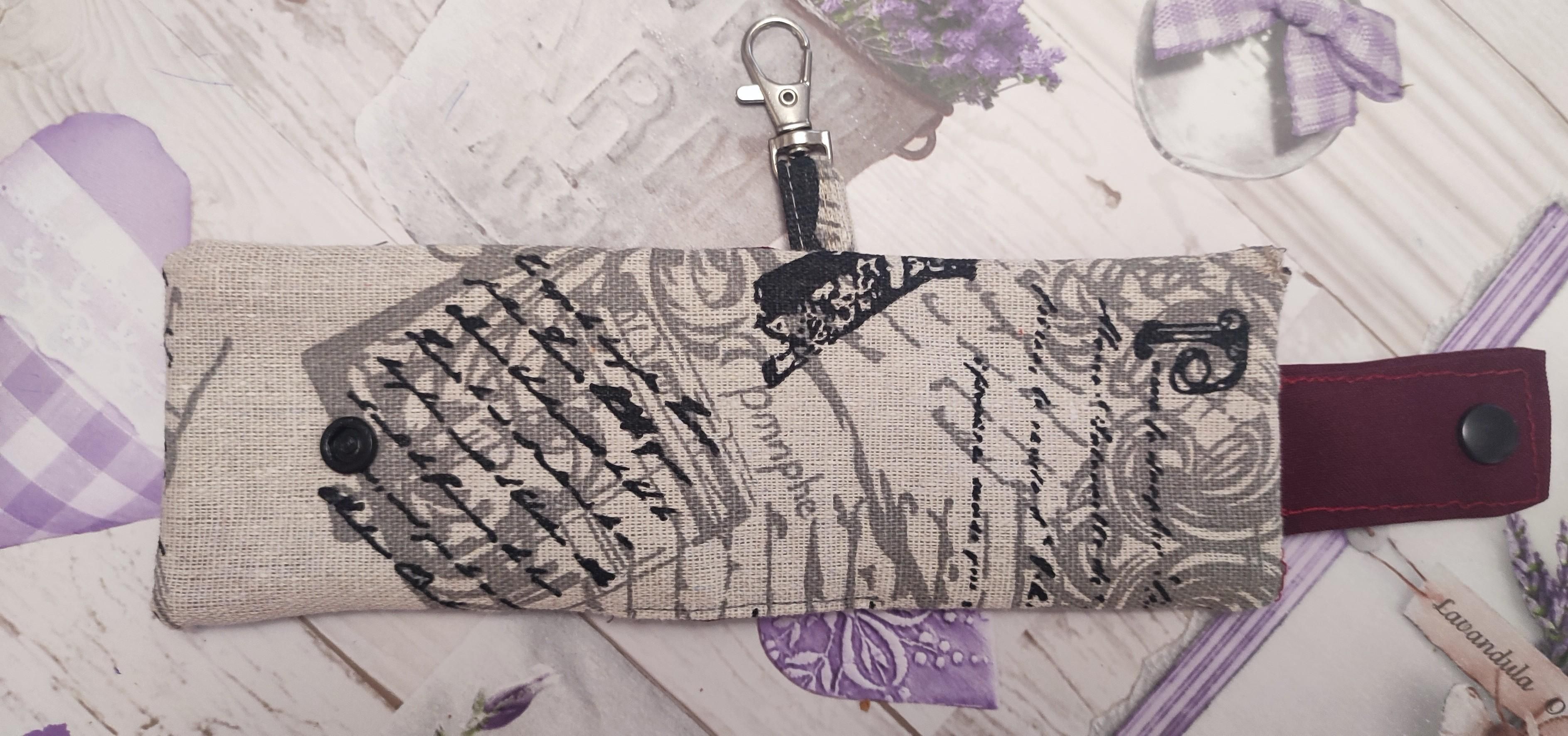 Open Keyring with card-holder handmade. Fabirc is a whitish colour wit the closure that is red and a black snap button. 