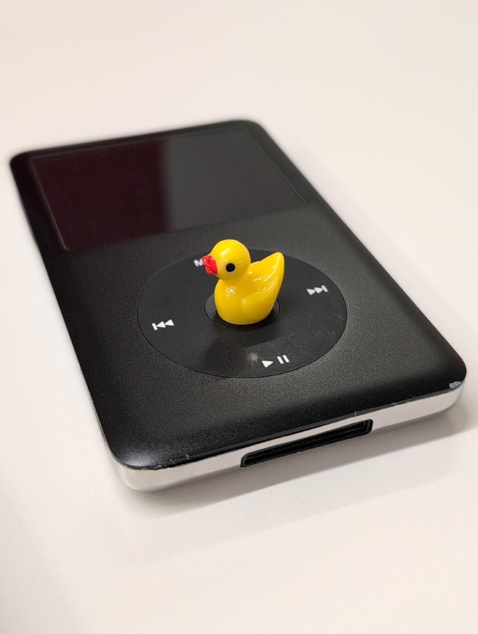Tiny yellow duck sitting on my black 6th gen iPod Classic's center button.