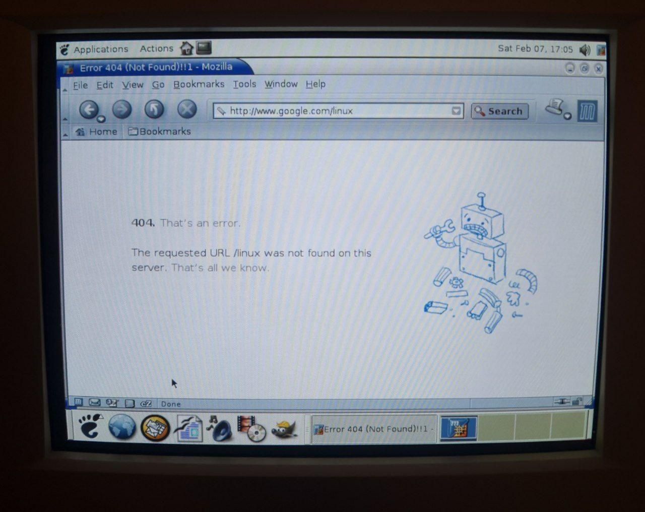 Mozilla Firefox showing a page that was supposed to be Google's search for Linux. Except it's a 404, and there's a drawing of a broken robot. A photo from a CRT