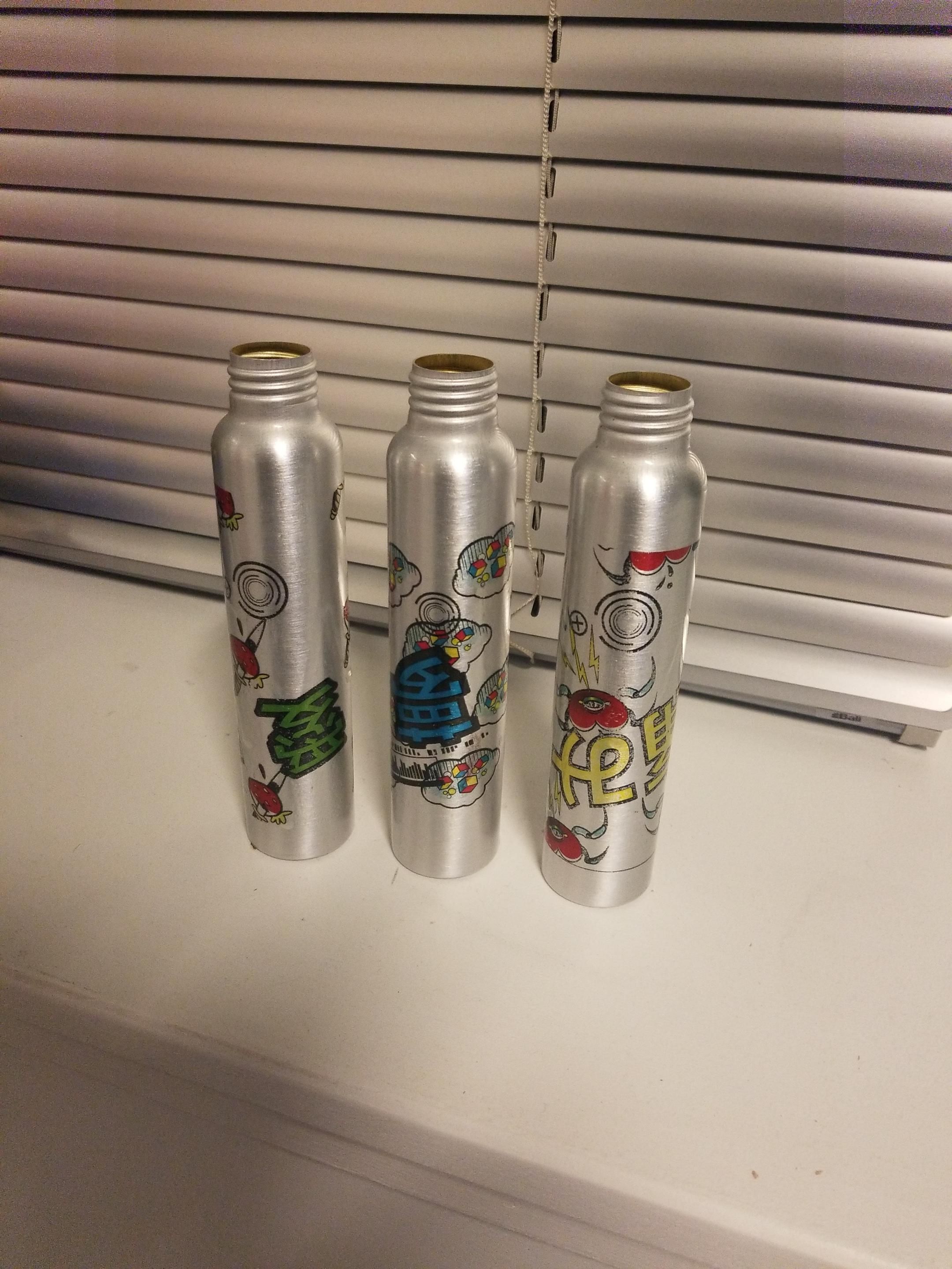3 drawn aluminum bottles with replica labels applied 
