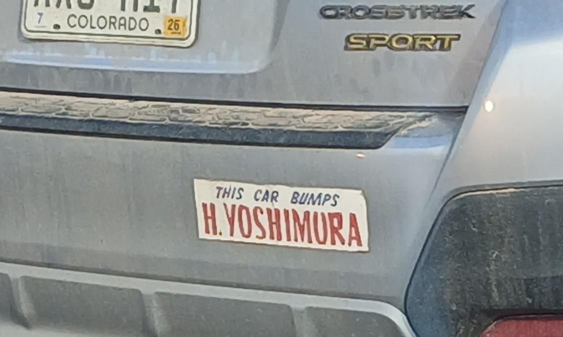 Bumper sticker reading this car bumps h. Yoshimura