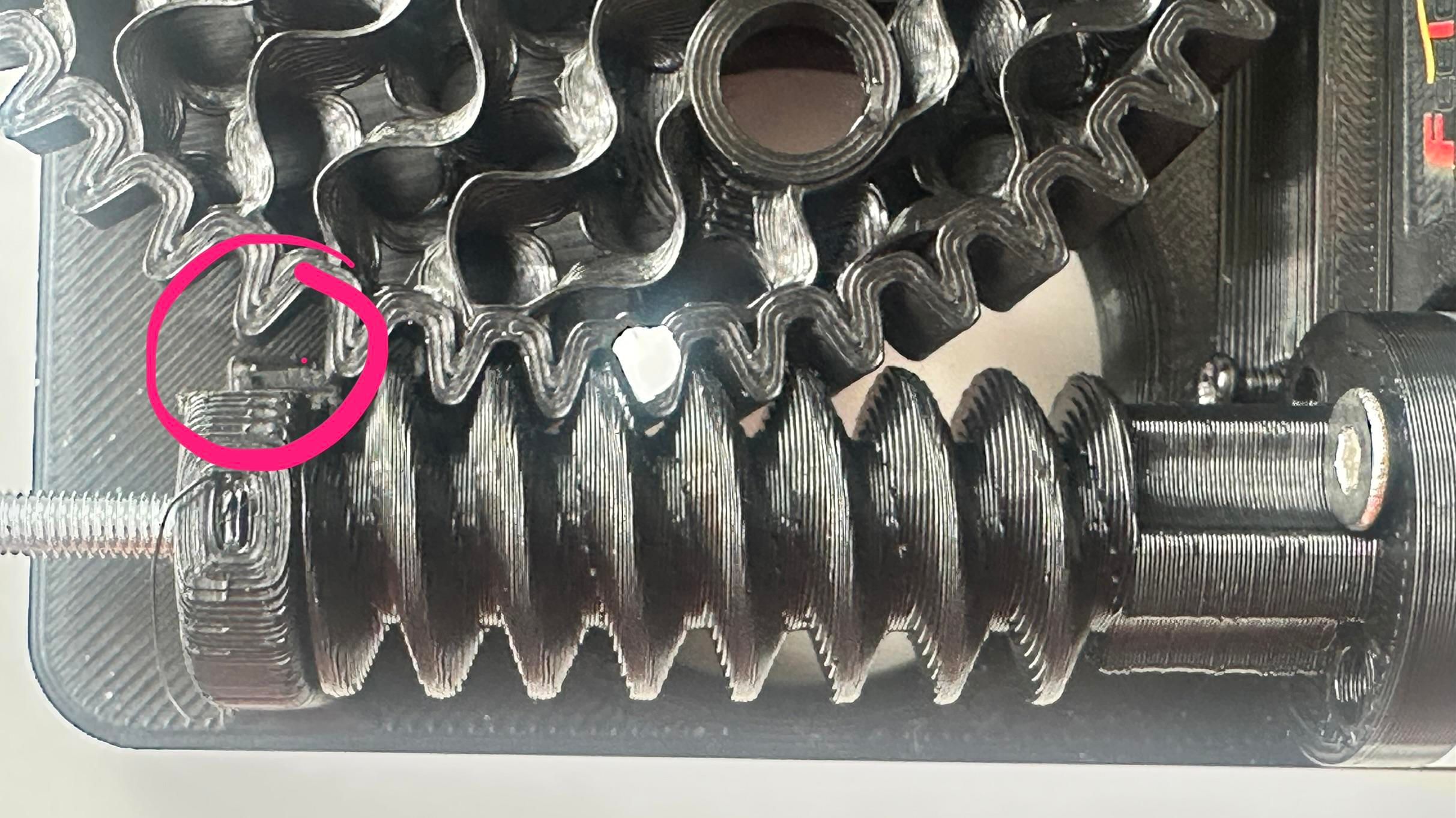 Top down view of the gear mesh with a circle highlighting where part has been cut away with a dremel. 